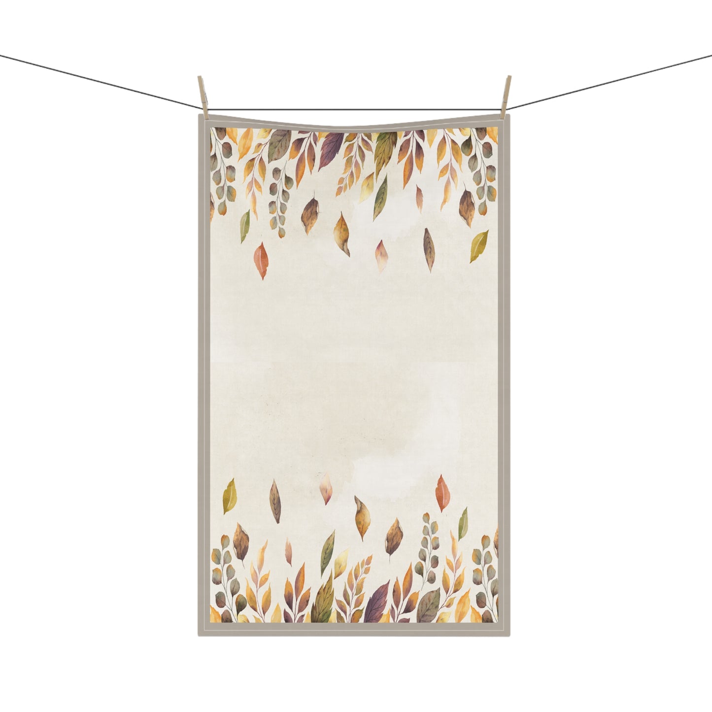 Tea towel with autumn leaf pattern hanging on a line