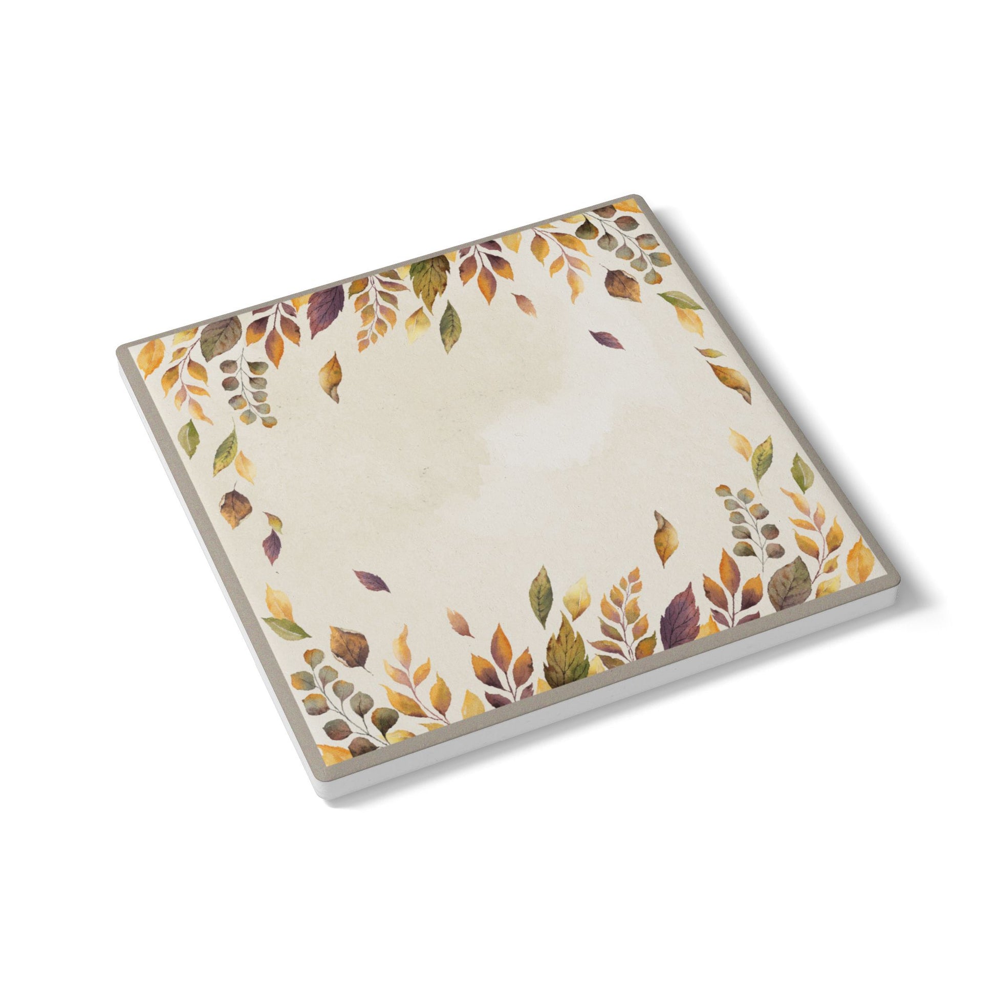 Coaster tile with autumn leaf design on a white background