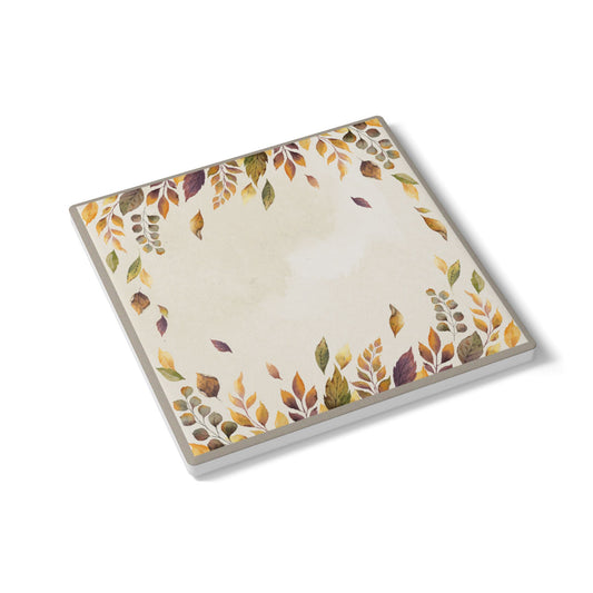 Coaster tile with autumn leaf design on a white background