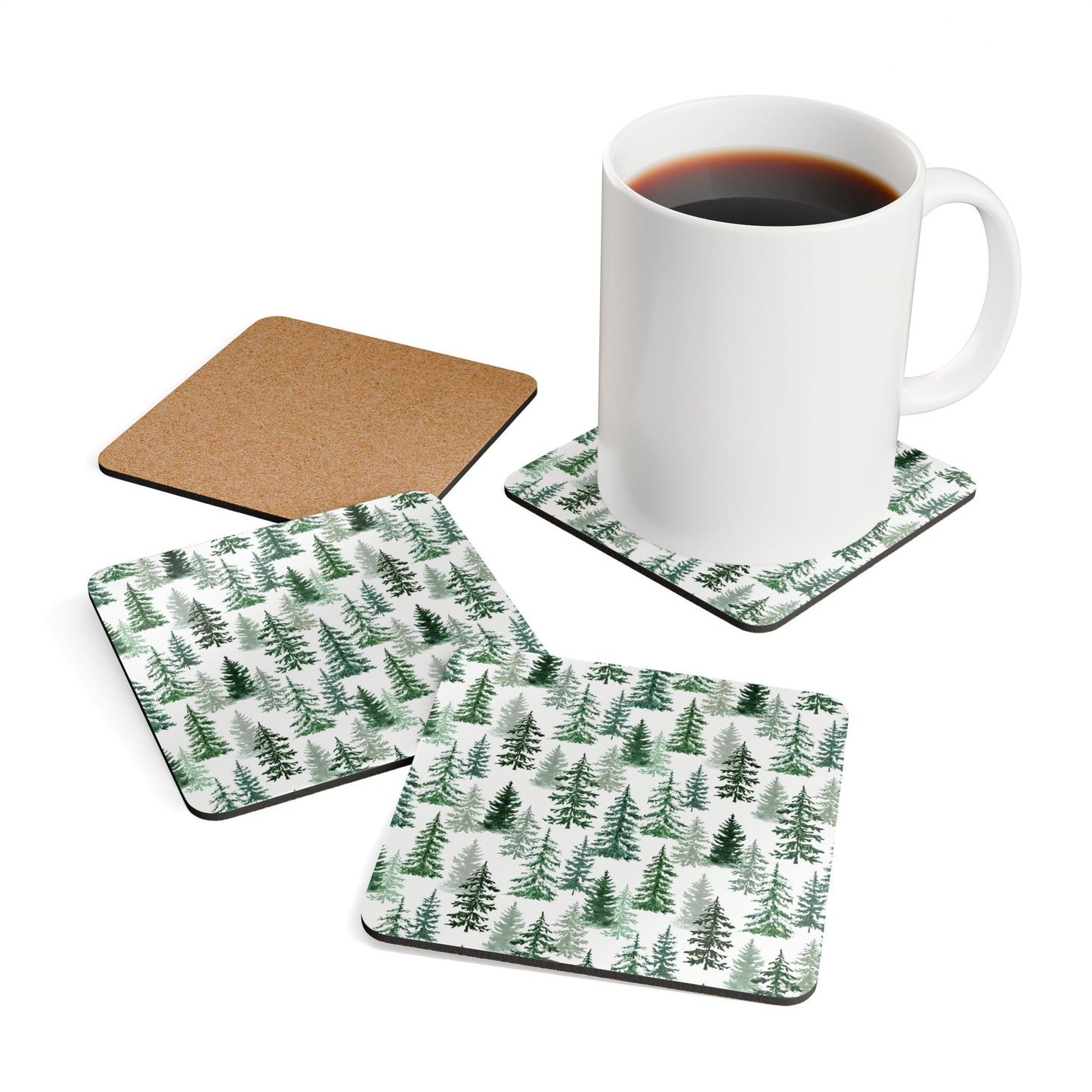 Set of four Fraser Fir coasters with green tree pattern, one coaster with a mug of coffee on a white background