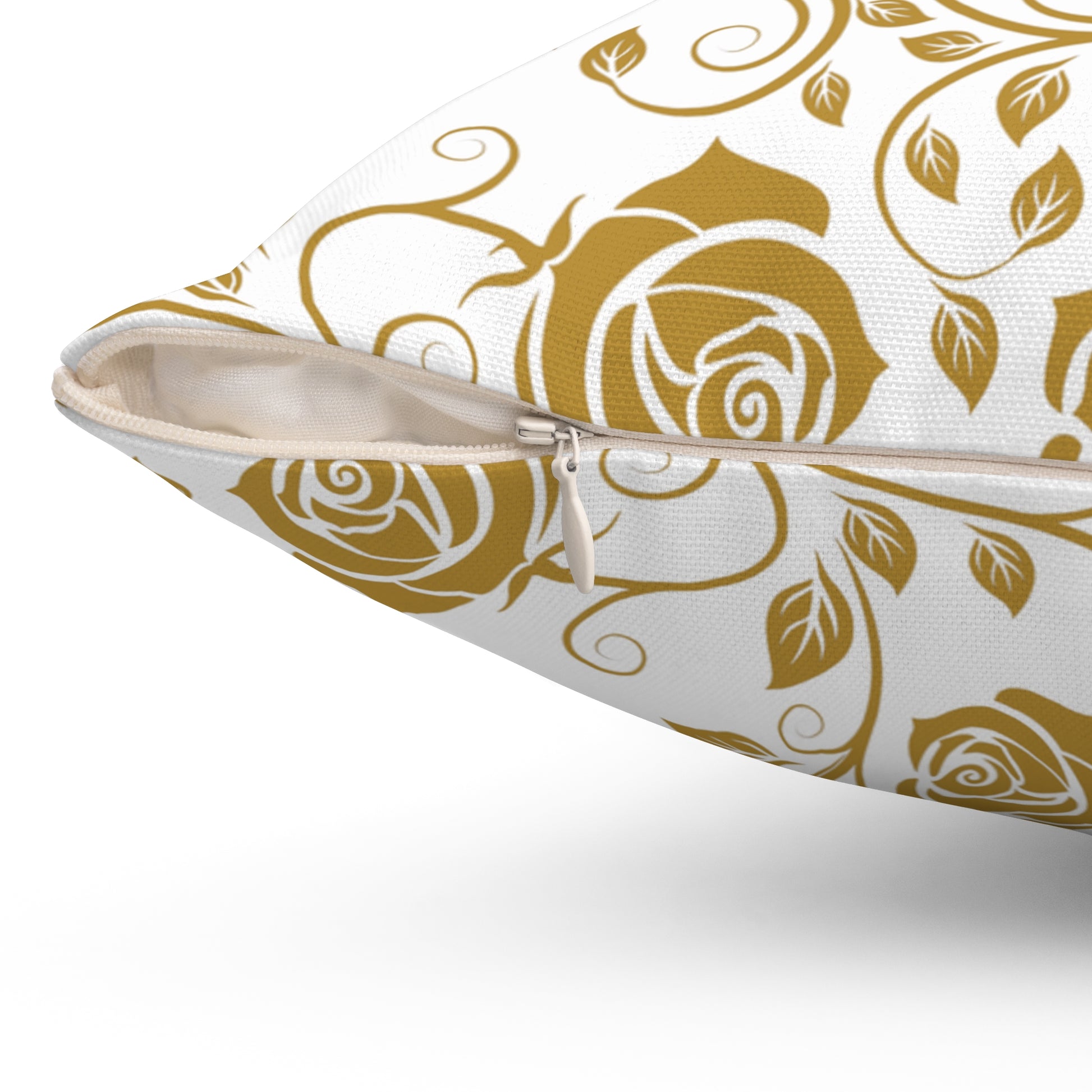 Decorative pillow with gold floral pattern on a white background