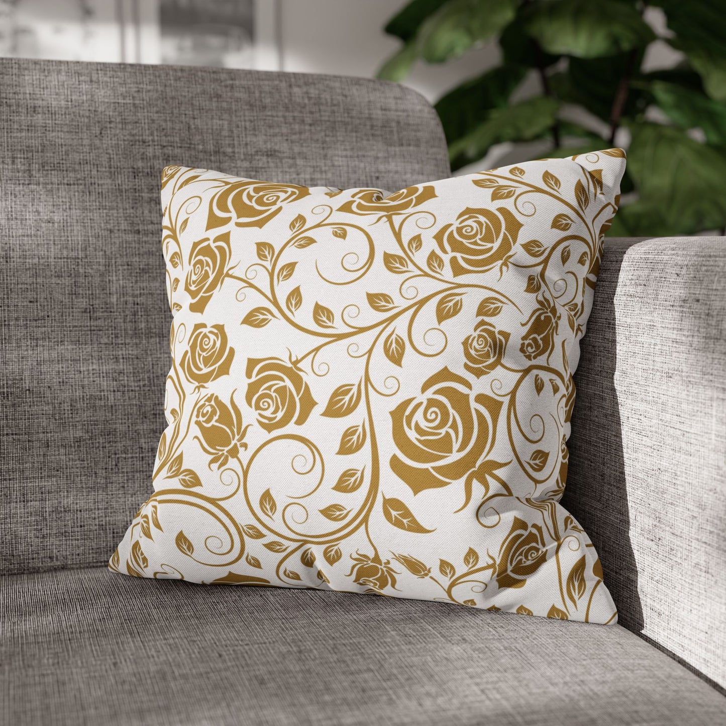 Decorative pillow with gold floral pattern on a gray sofa