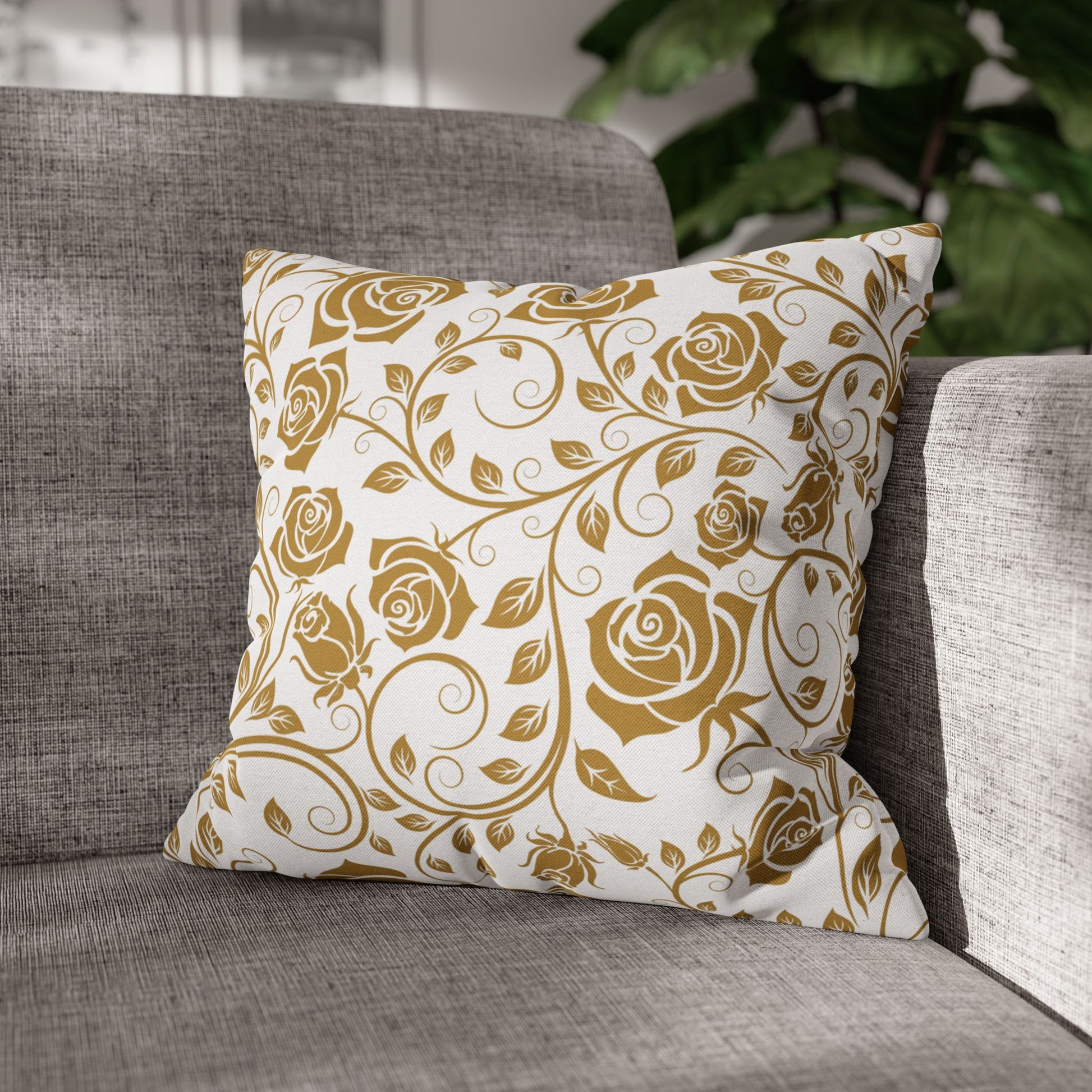 Decorative pillow with gold floral pattern on a gray sofa