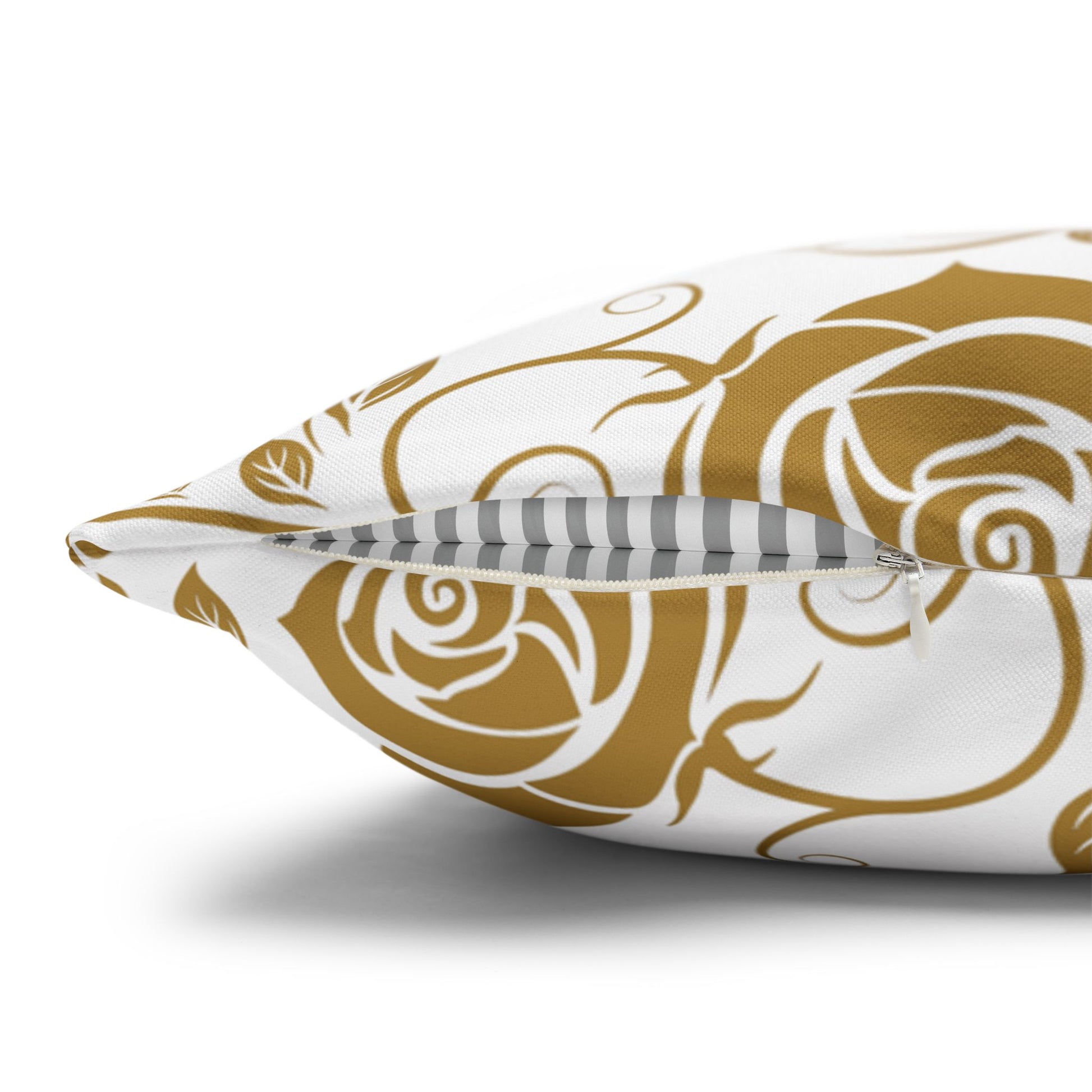 Decorative pillow with gold floral pattern with zipper closure on white background