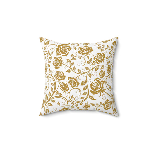 Decorative pillow with gold floral pattern on a white background
