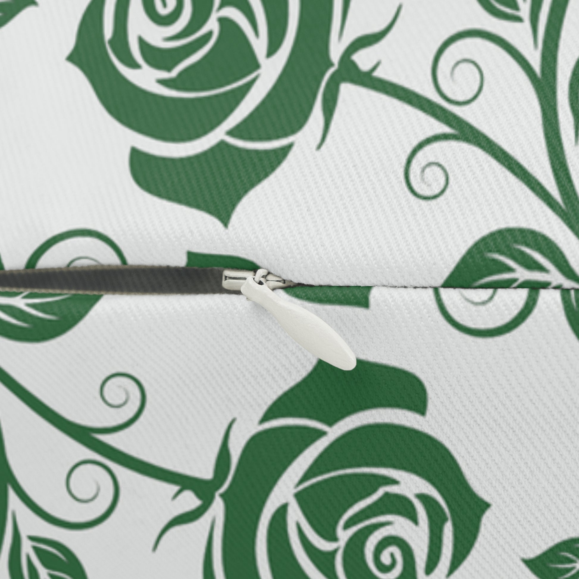 Close-up of a zipper on a green and white pillow with green rose pattern