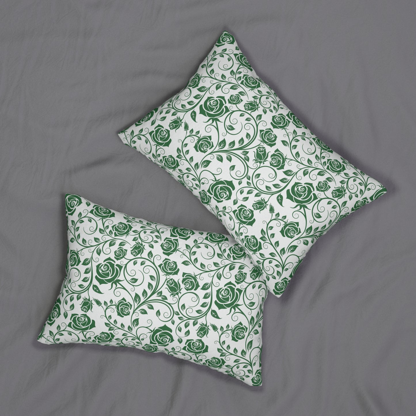 Two green and white floral patterned pillows on a gray surface