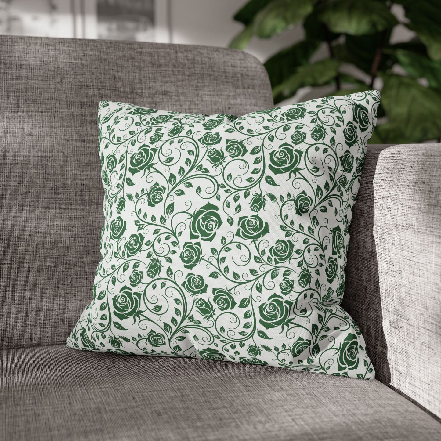 Green floral patterned pillow on a gray sofa