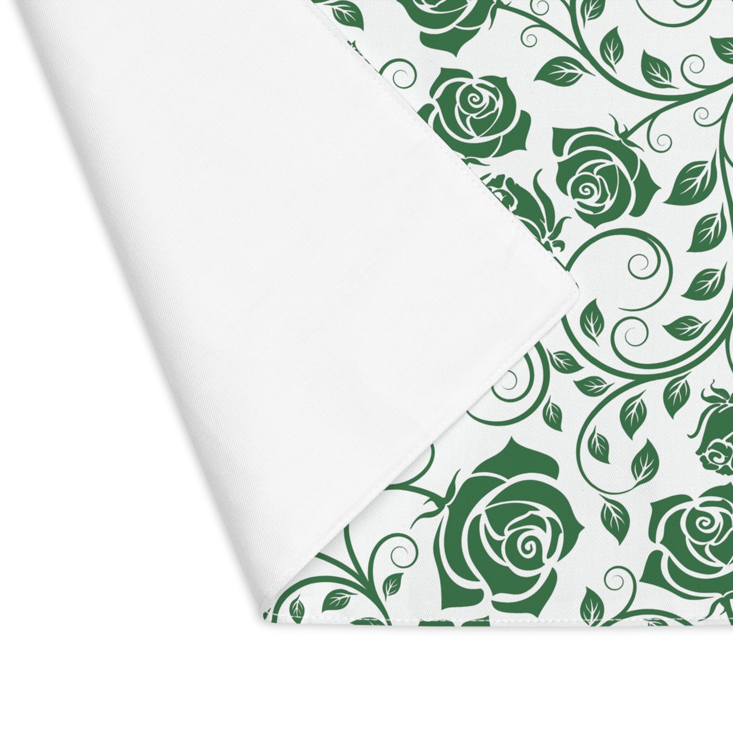 Green rose floral pattern placemat on white background with one corner folded over to reveal white backside