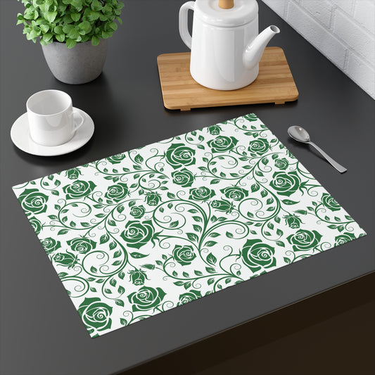 Placemat with green rose pattern on a table with tea set and plant.