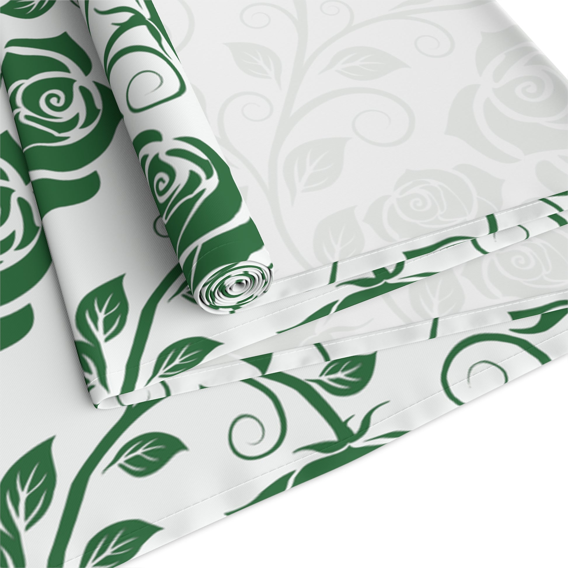 Green floral pattern table runner rolled up and folded on white background
