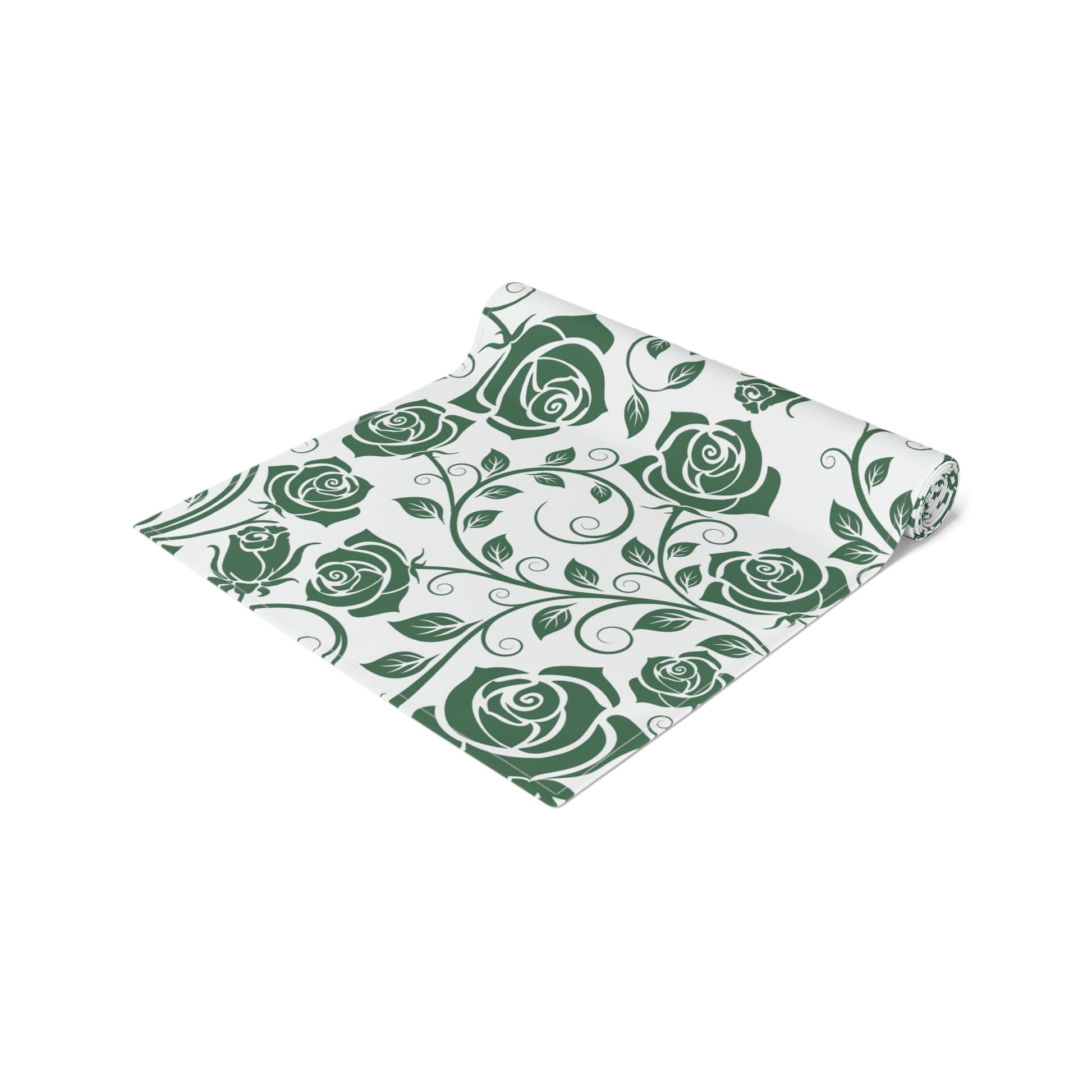 Table runner with green rose pattern rolled up on a white background