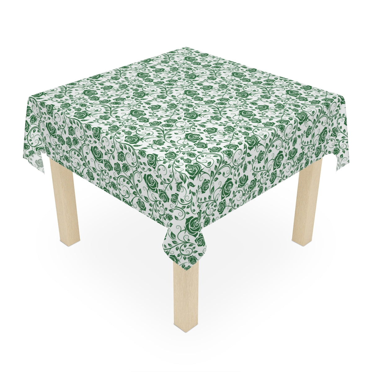 Table with a green and white rose patterned tablecloth on a white background