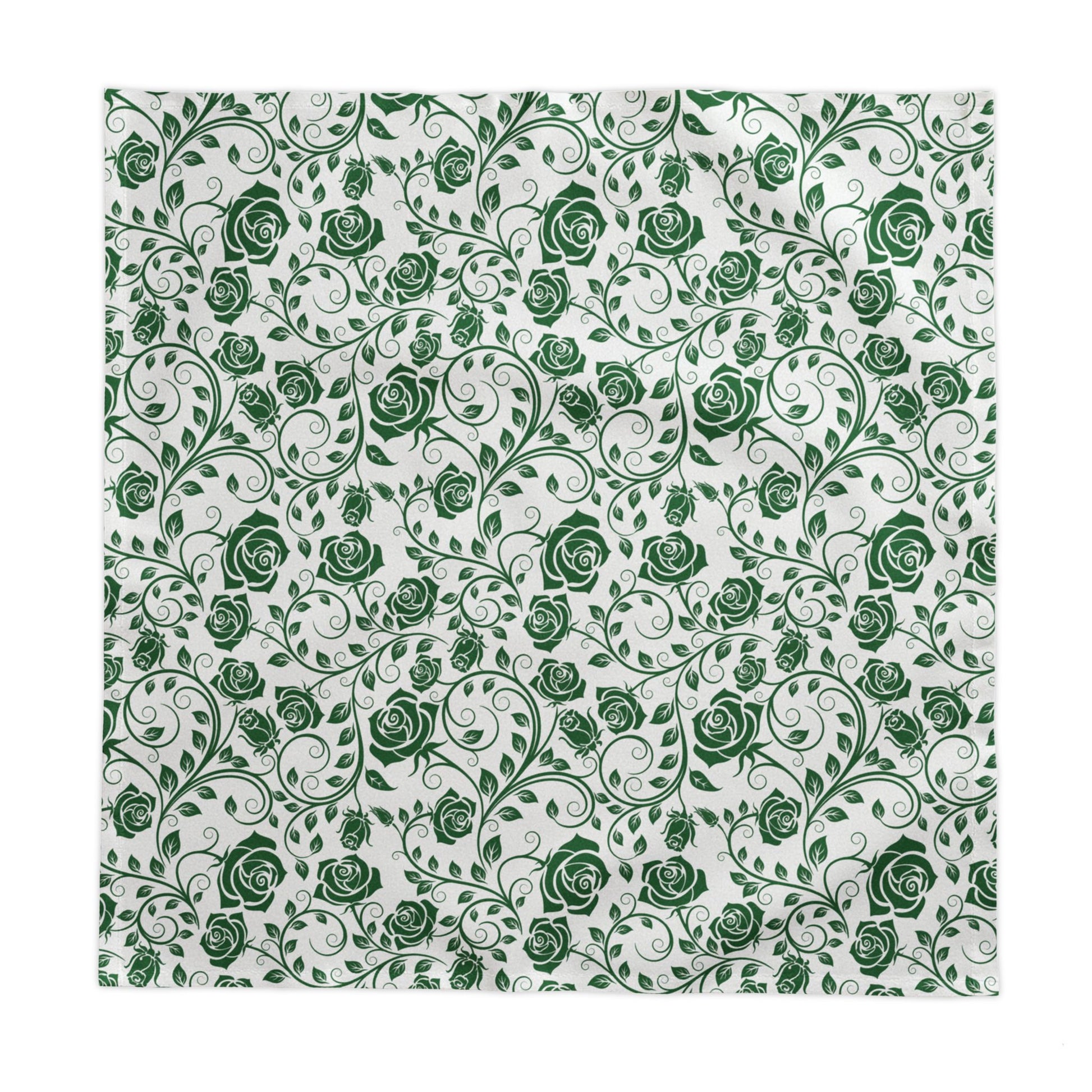 Green and white floral pattern square tablecloth on a white background