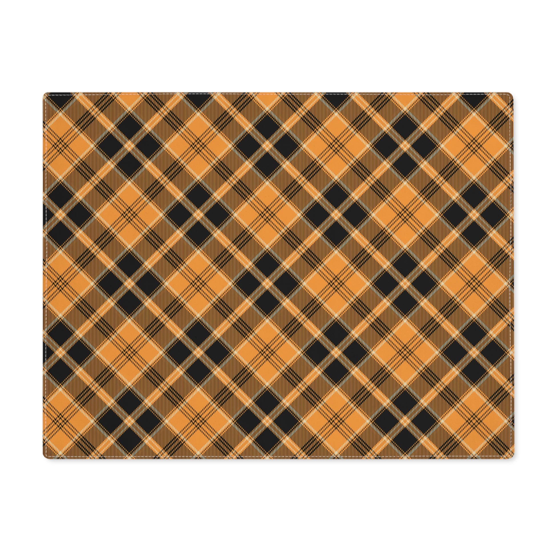 Halloween Plaid placemat has plaid pattern in orange and black colors printed on top of placemat, on a white background.