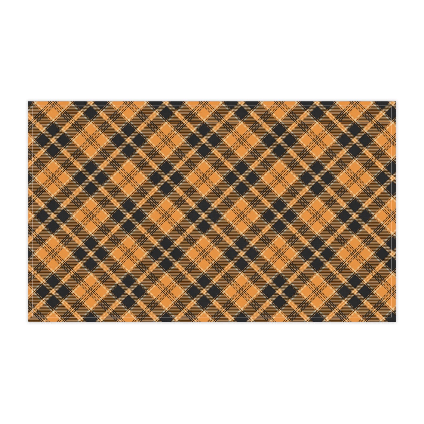 Halloween Plaid tea towel has a plaid pattern with orange and black colors, on front of tea kitchen towel, on a white background