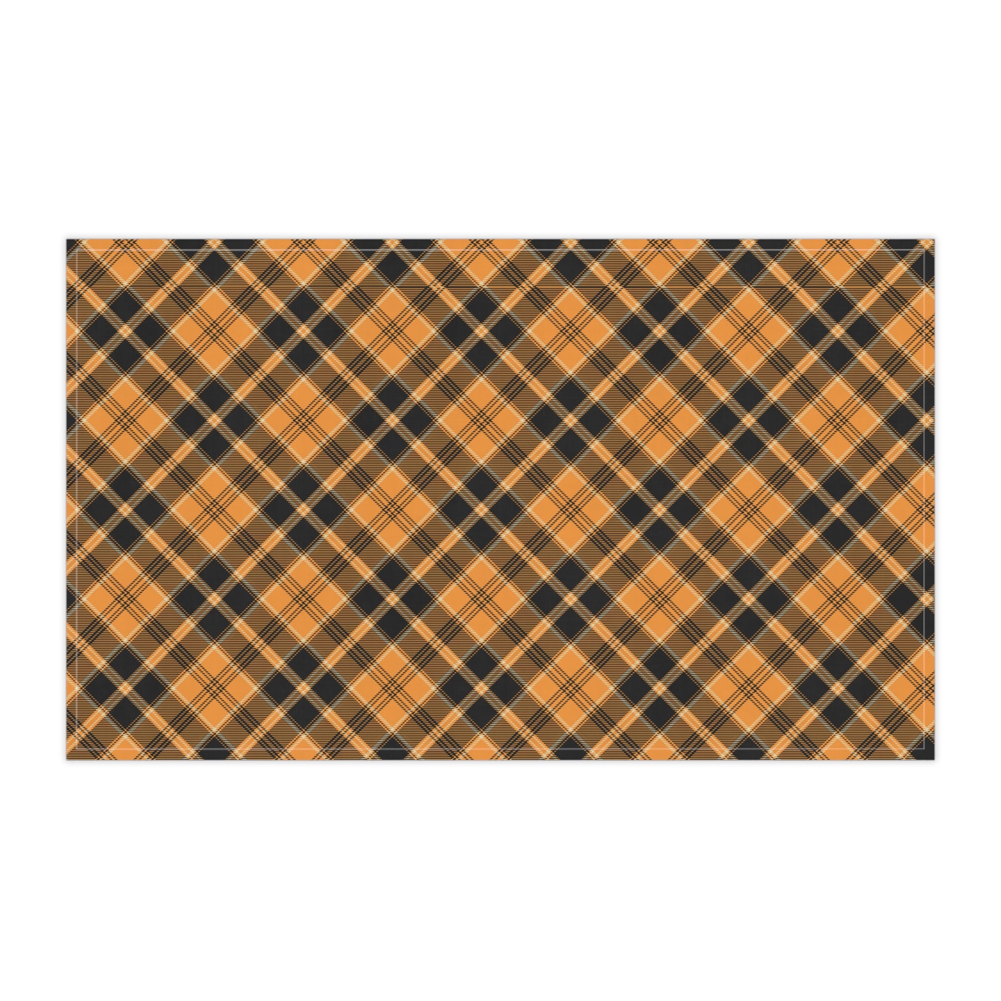 Halloween Plaid tea towel has a plaid pattern with orange and black colors, on front of tea kitchen towel, on a white background