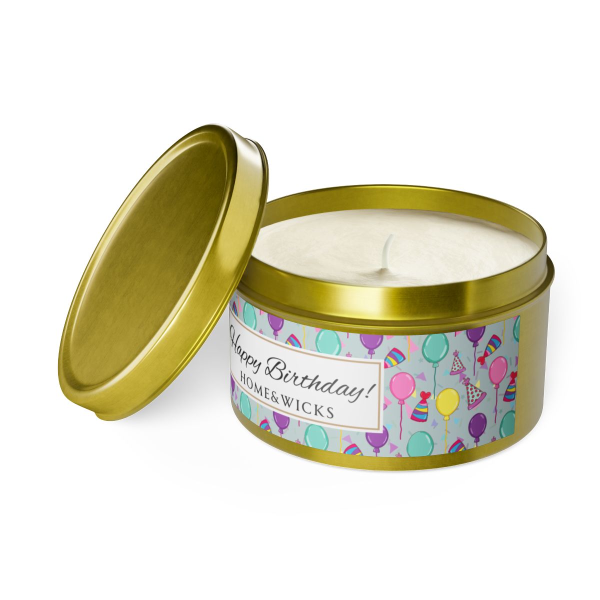 Open gold candle tin with 'Happy Birthday' label with colorful balloon, birthday hats and confetti design on a white background