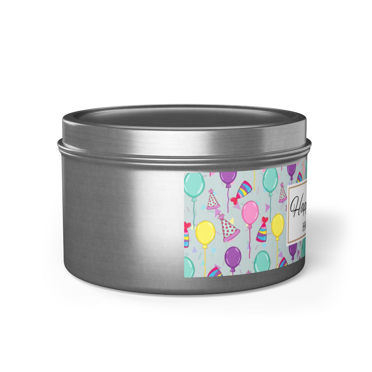 Side view of silver candle tin with 'Happy Birthday' label and colorful balloon, birthday hats and confetti design on a white background