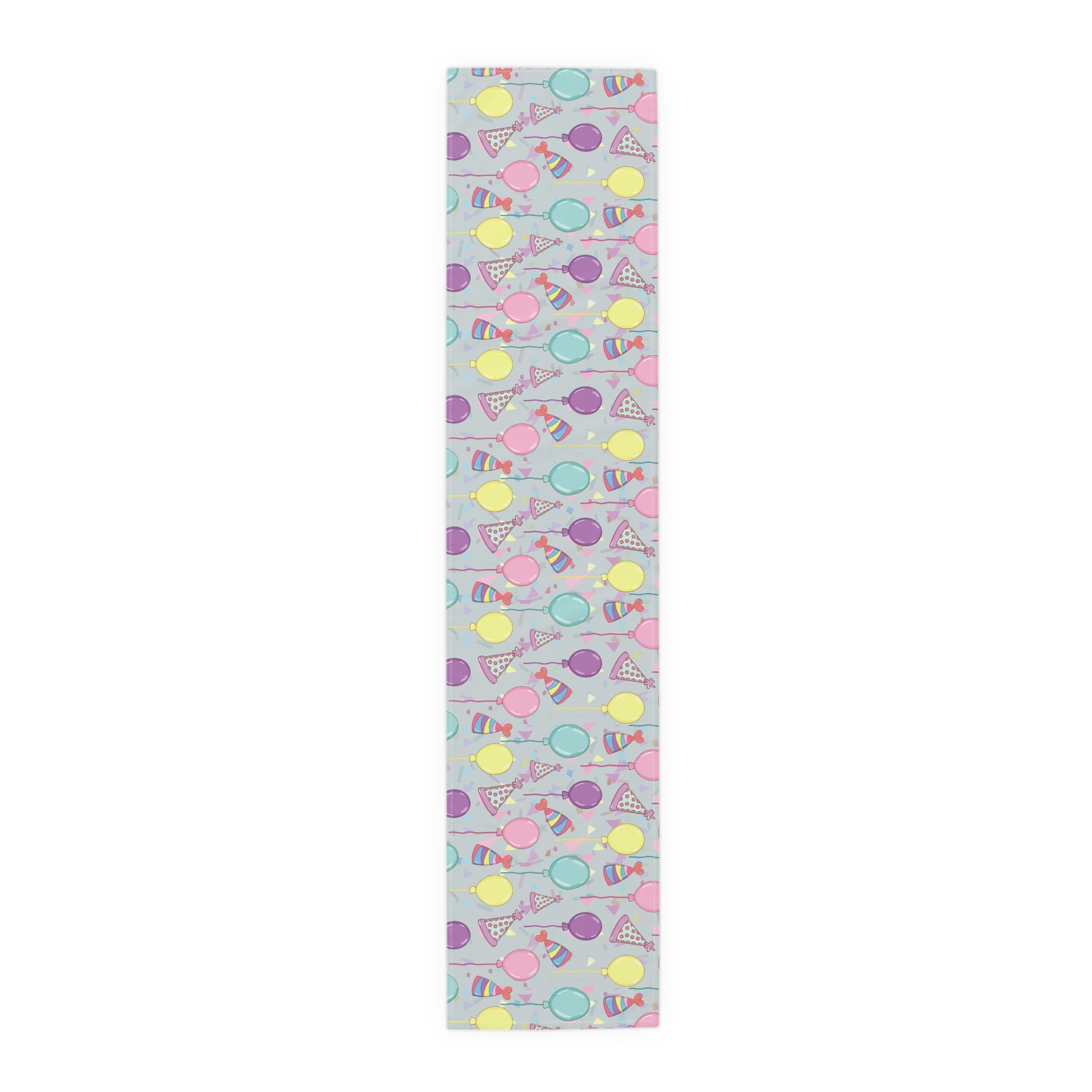 Table runner with colorful birthday party hats, confetti and balloons pattern on a light gray background