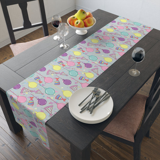 Table runner with colorful birthday party hats, confetti and balloons pattern on a dining table