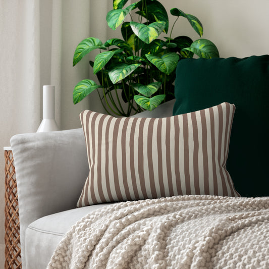 Mocha striped lumbar decorative throw pillow on a sofa with a plant in the background