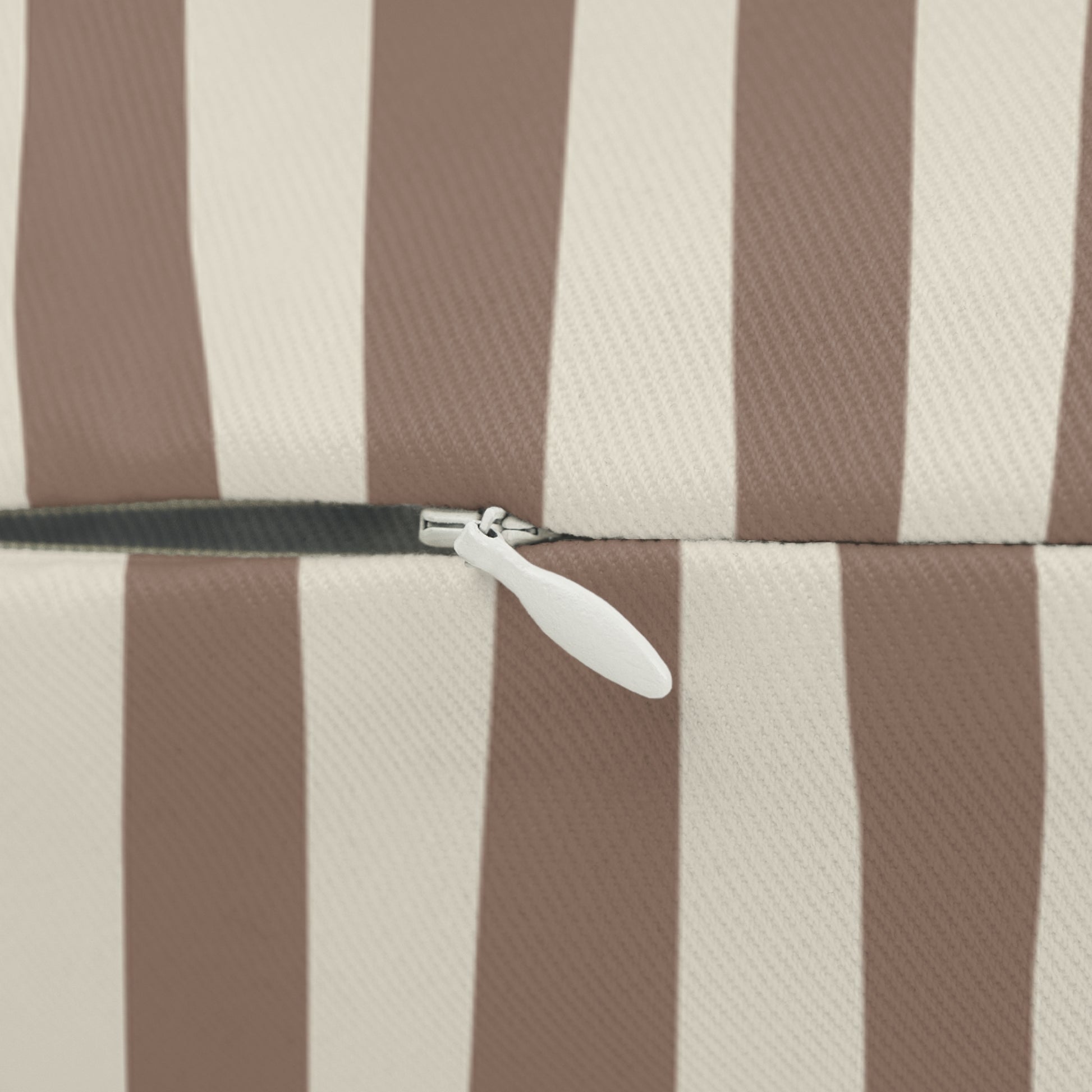 Close-up of a zipper on a Mocha striped brown and beige striped decorative throw pillow