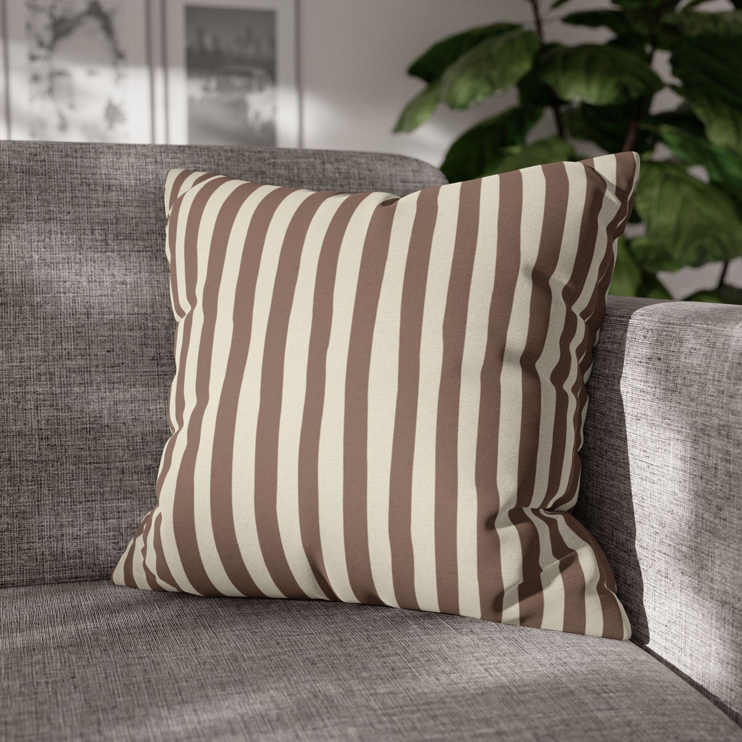 Mocha brown striped decorative throw pillow on a gray sofa with a blurred indoor background