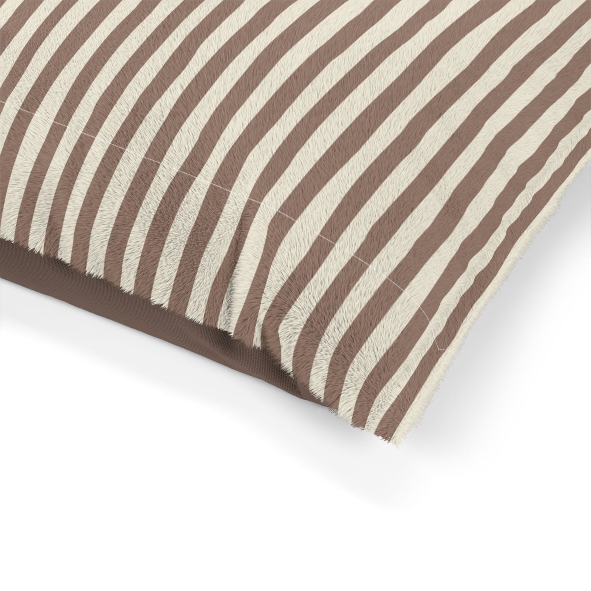 Corner of mocha brown striped pet dog bed with brown and beige stripes on a white background