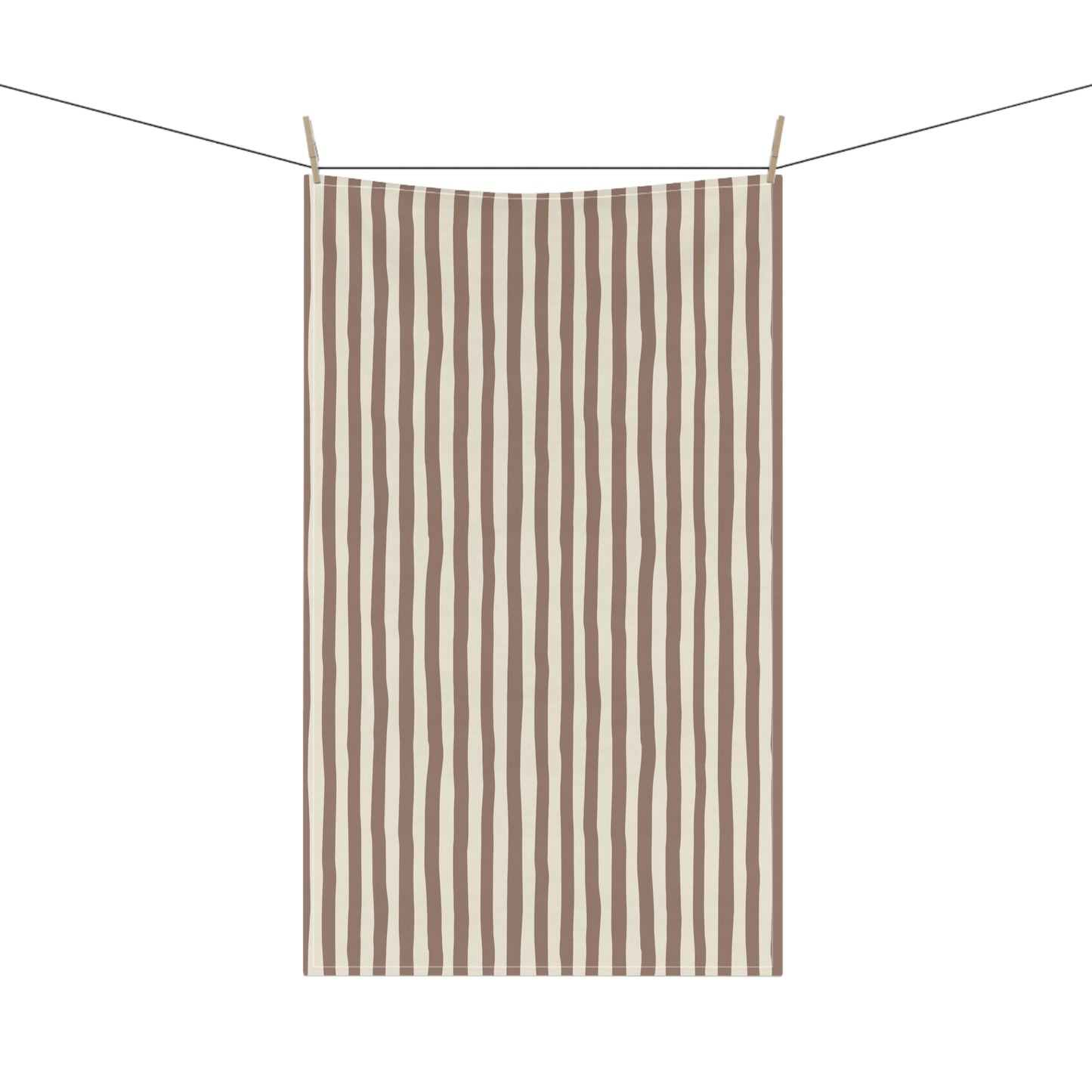 Mocha brown and beige striped towel hanging on a clothesline with a white background