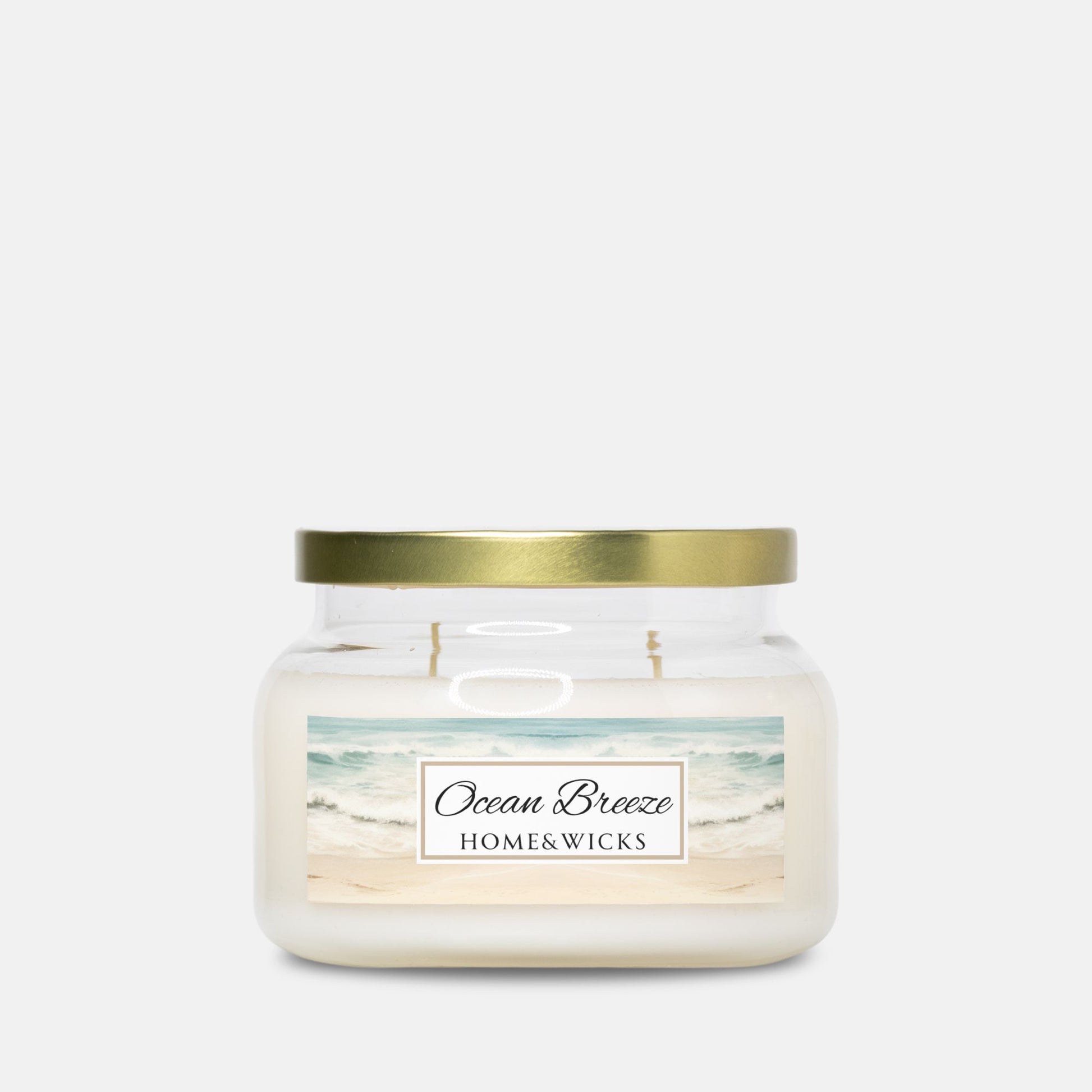 Double wicked apothecary candle jar labeled 'Ocean Breeze' by Home & Wicks on a white background w