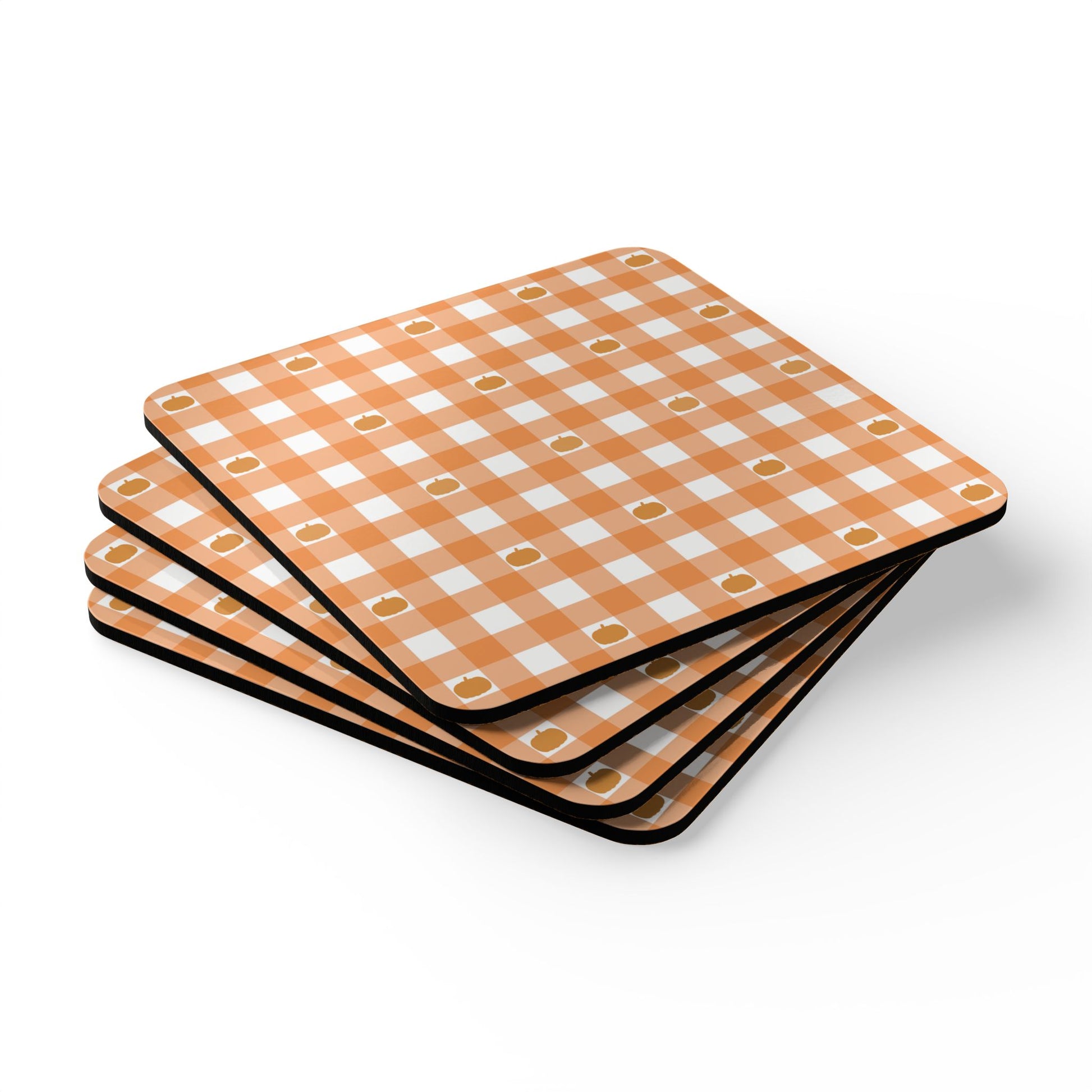 Set of four orange and white gingham checkered with pumpkins coasters on a white background