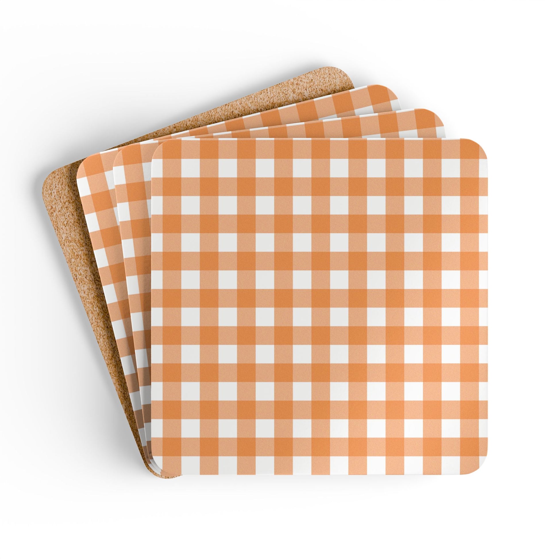 Set of four orange and white gingham checkered coasters with cork backing on a white background