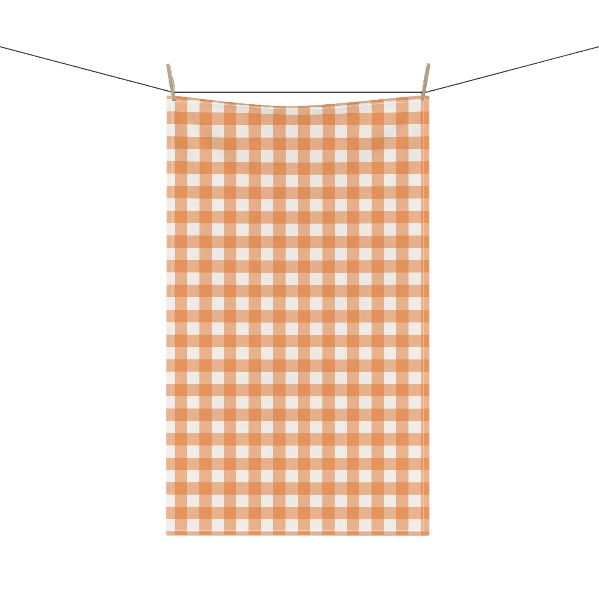 Orange and white gingham checkered tea towel hanging on a line against a white background