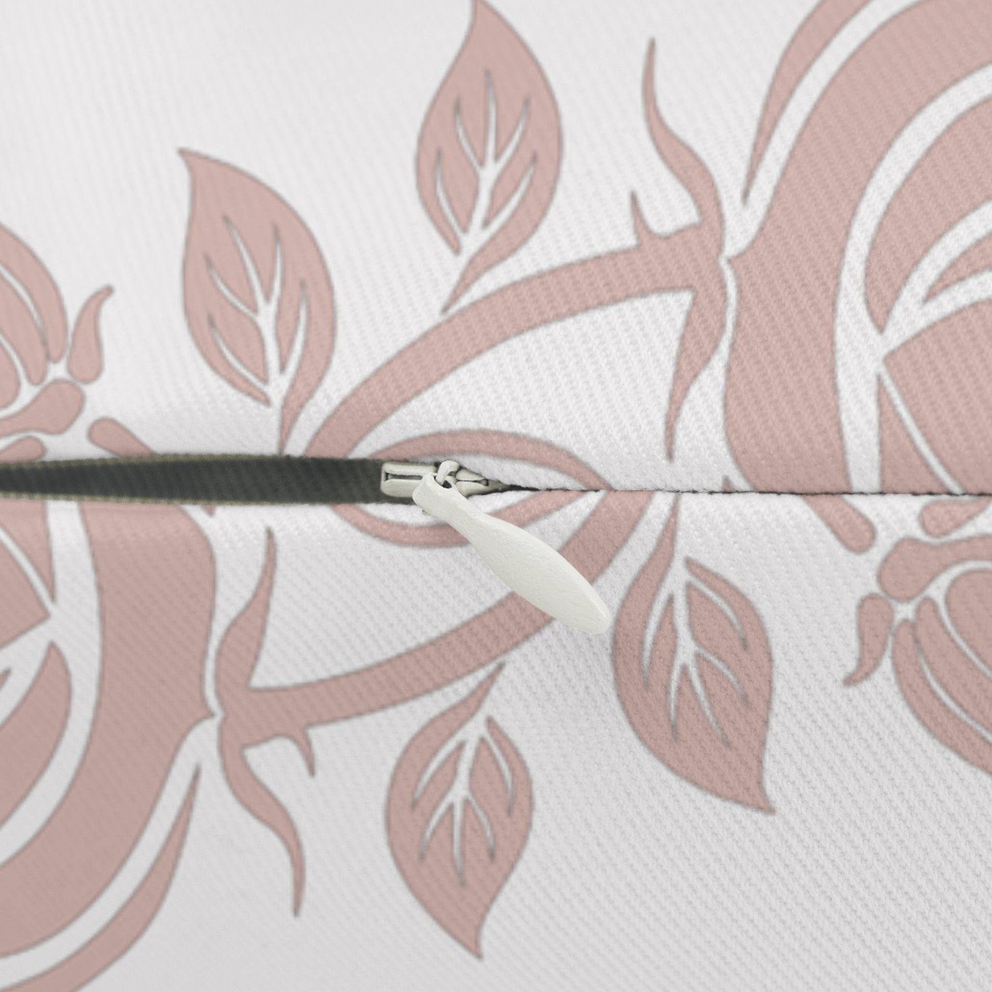 Close-up of a pillow zipper closure  with a pink floral patterned background