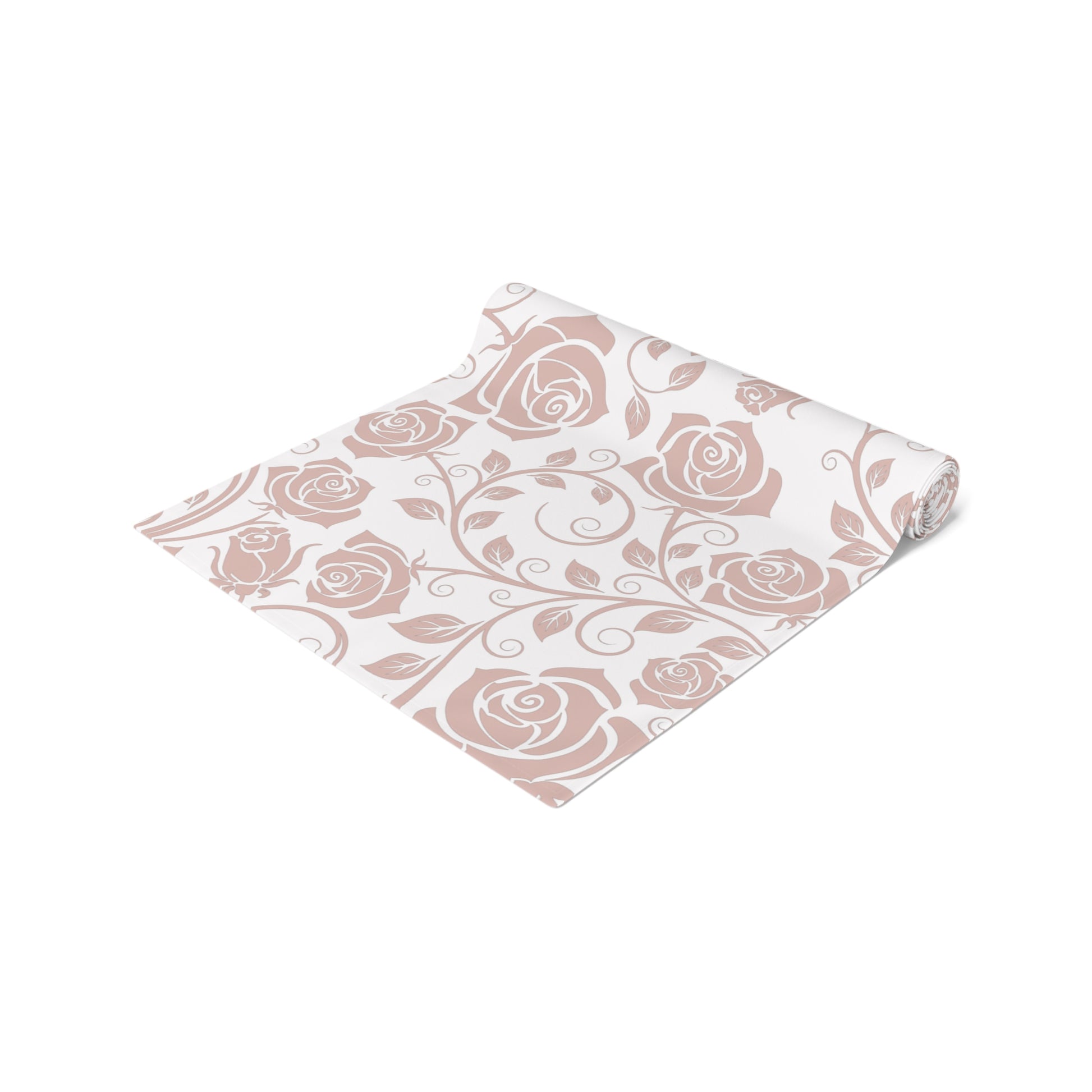 Pink floral patterned table runner rolled up on a white background