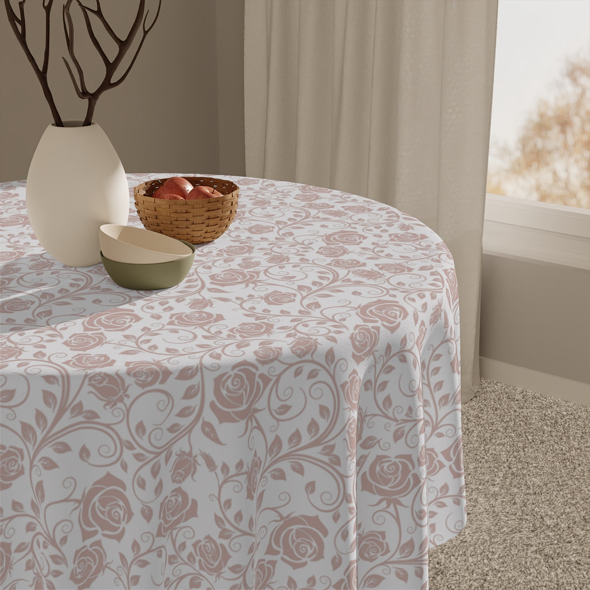 Round table with a pink & white floral patterned tablecloth, decorative bowl, and vase against a neutral background.