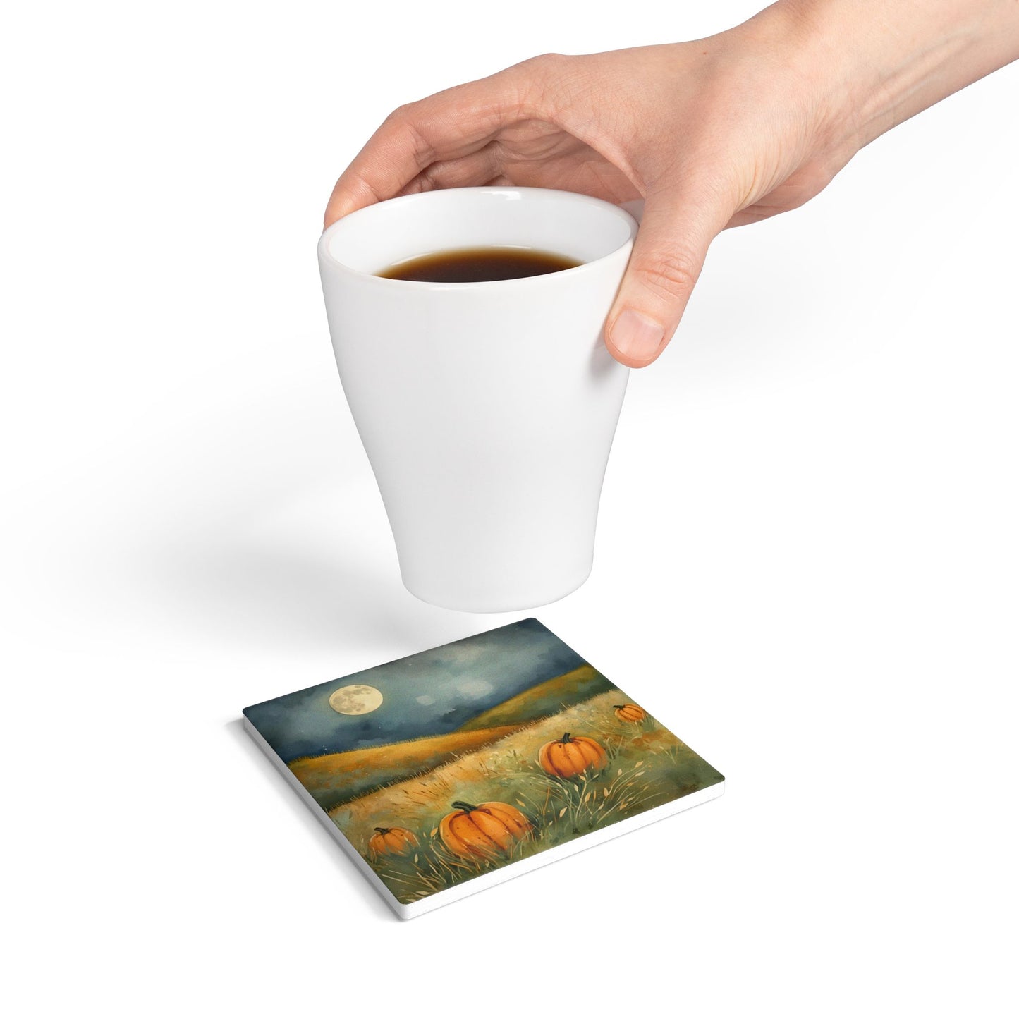 Pumpkin Patch ceramic tile coaster has white and orange pumpkins in grass with orange tulips printed on top of the tile coaster on a white background