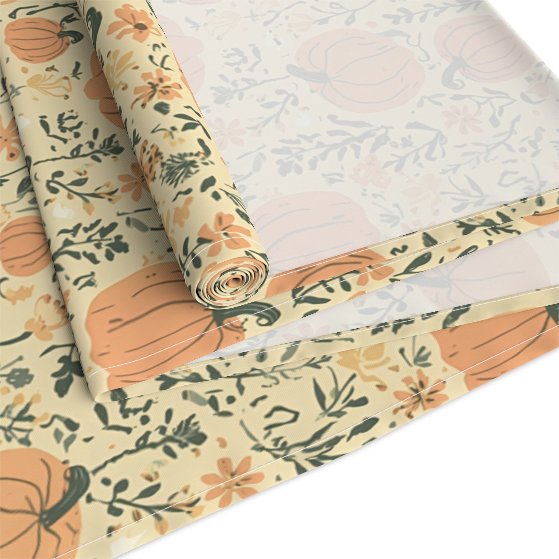 Our cotton twill Pumpkin Garden table runner has an orange pumpkin and flowers table runner design and is rolled up on a white background