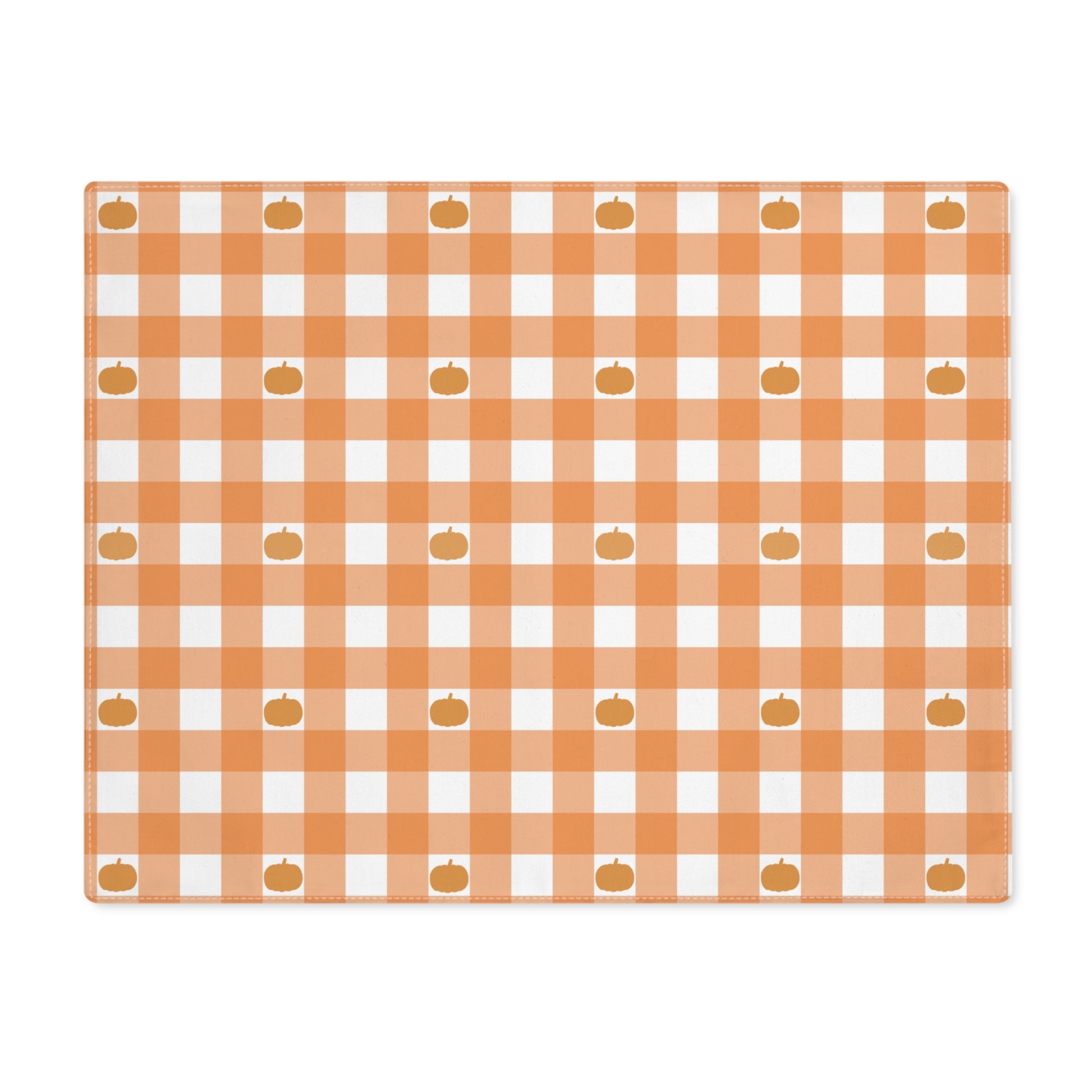 Our Pumpkin Gingham placemat has an orange and white checkered pattern with small pumpkins on the cotton twill placemat fabric  on a white background