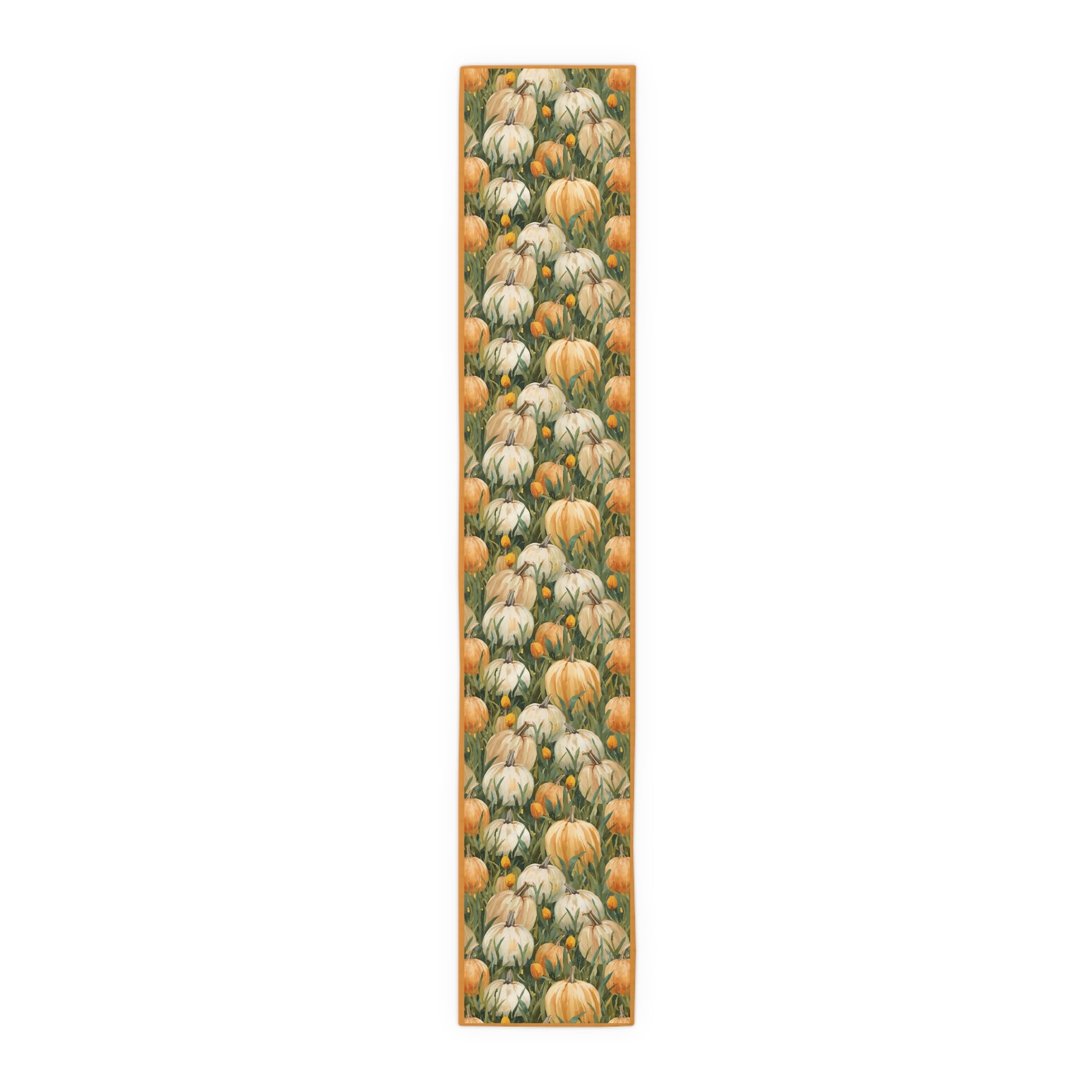 Pumpkin Patch table runner has white and orange pumpkins in grass with orange tulips printed on front of table runner polyester fabric and sits on a white background