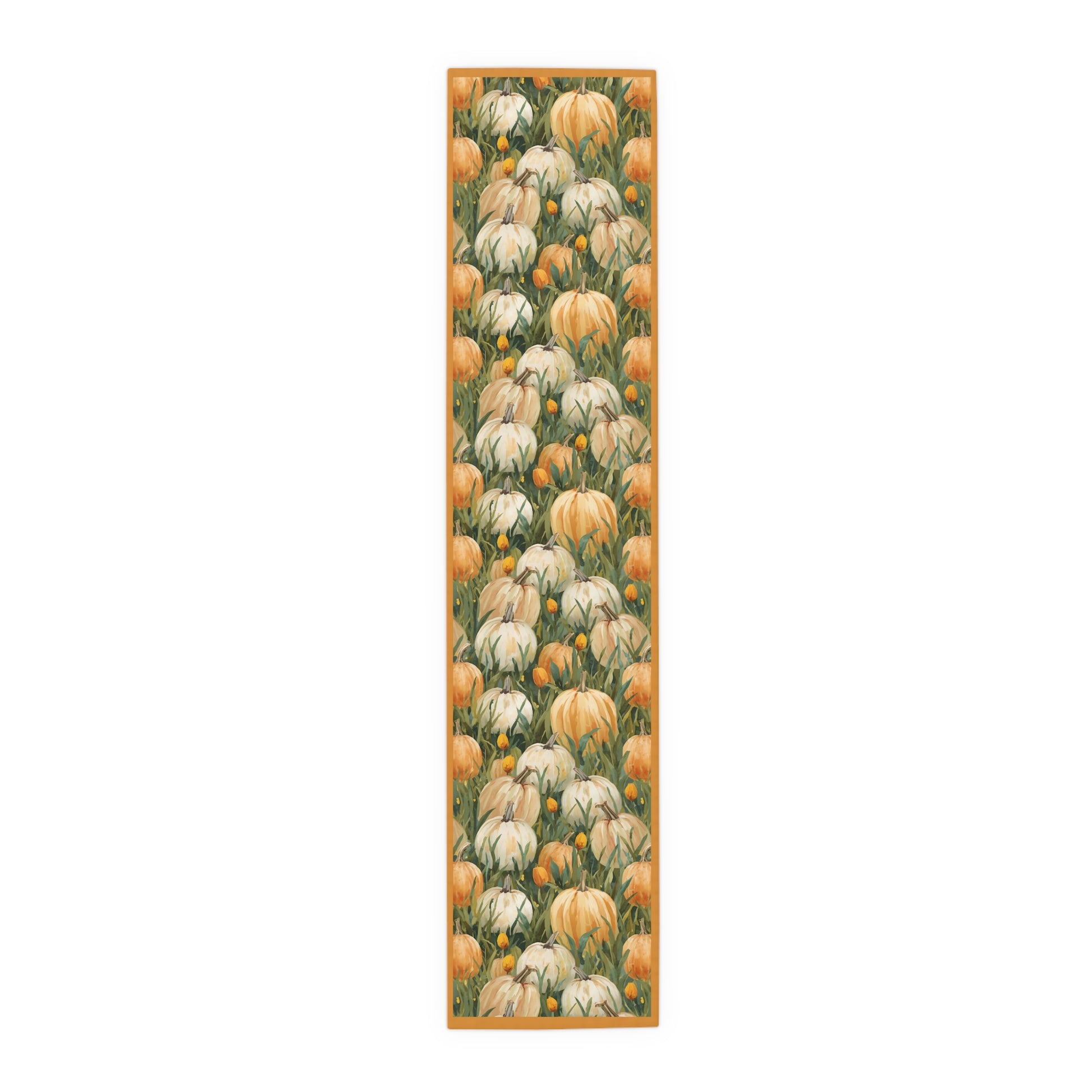 Pumpkin Patch table runner has white and orange pumpkins in grass with orange tulips printed on front of table runner polyester fabric on a white background