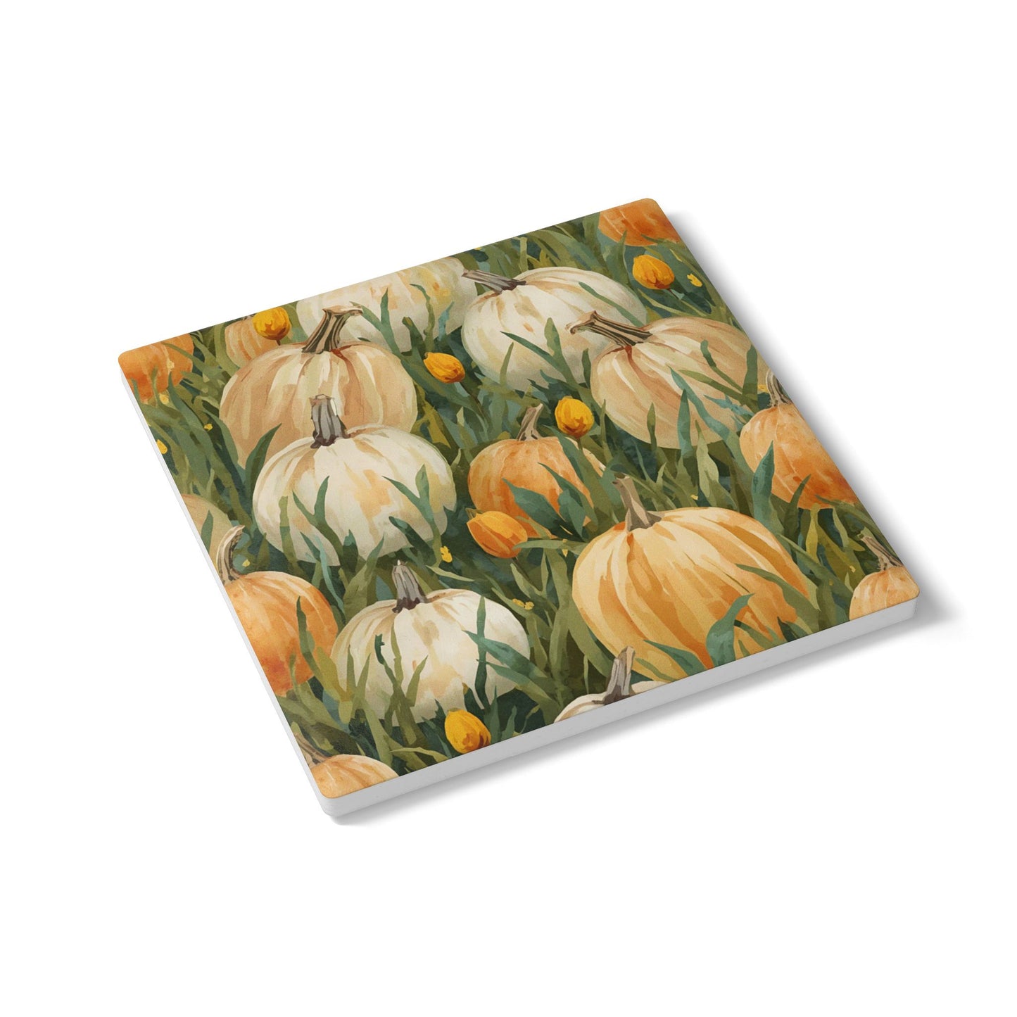 Pumpkin Patch ceramic tile coaster has white and orange pumpkins in grass with orange tulips printed on top of the tile coaster on a white background.