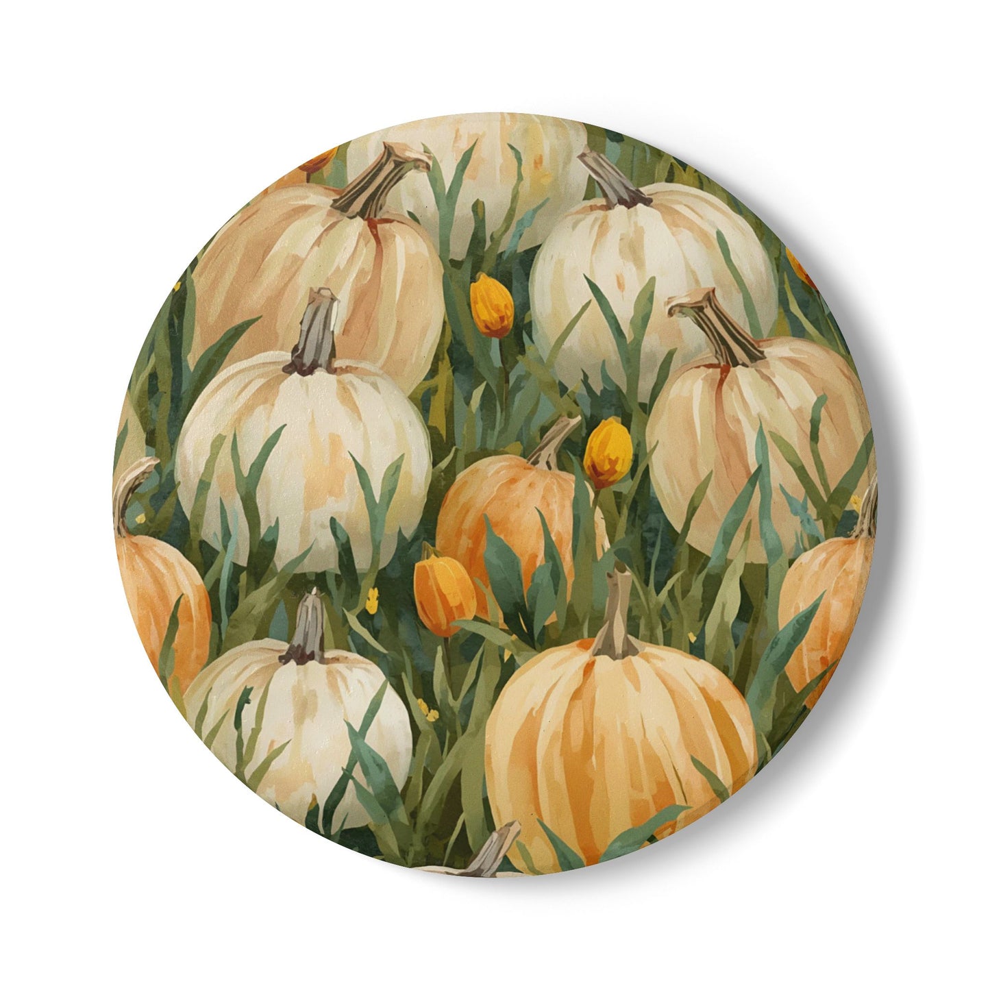 Pumpkin Patch round ceramic tile coaster has white and orange pumpkins in grass with orange tulips printed on top of the tile coaster on a white background
