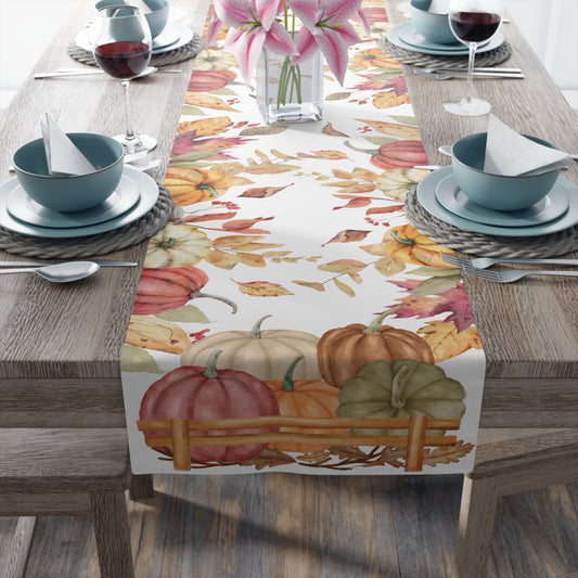 Table runner with autumn leaf and pumpkins pattern printed on front of this Pumpkins table runner, on a table setting with this colorful fall-themed table runner featuring pumpkins and leaves on a wooden table.
