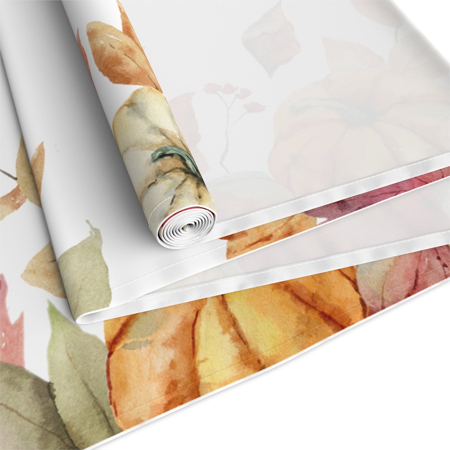Table runner with autumn leaf and pumpkins pattern printed on front of this Pumpkins polyester table runner, rolled up and folded on a white background.