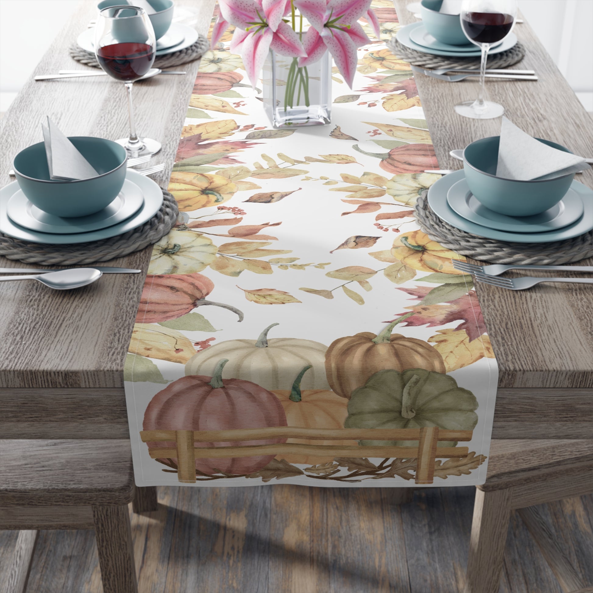 Table runner with autumn leaf and pumpkins pattern printed on front of this Pumpkins cotton twill table runner on a table setting on a wooden table.