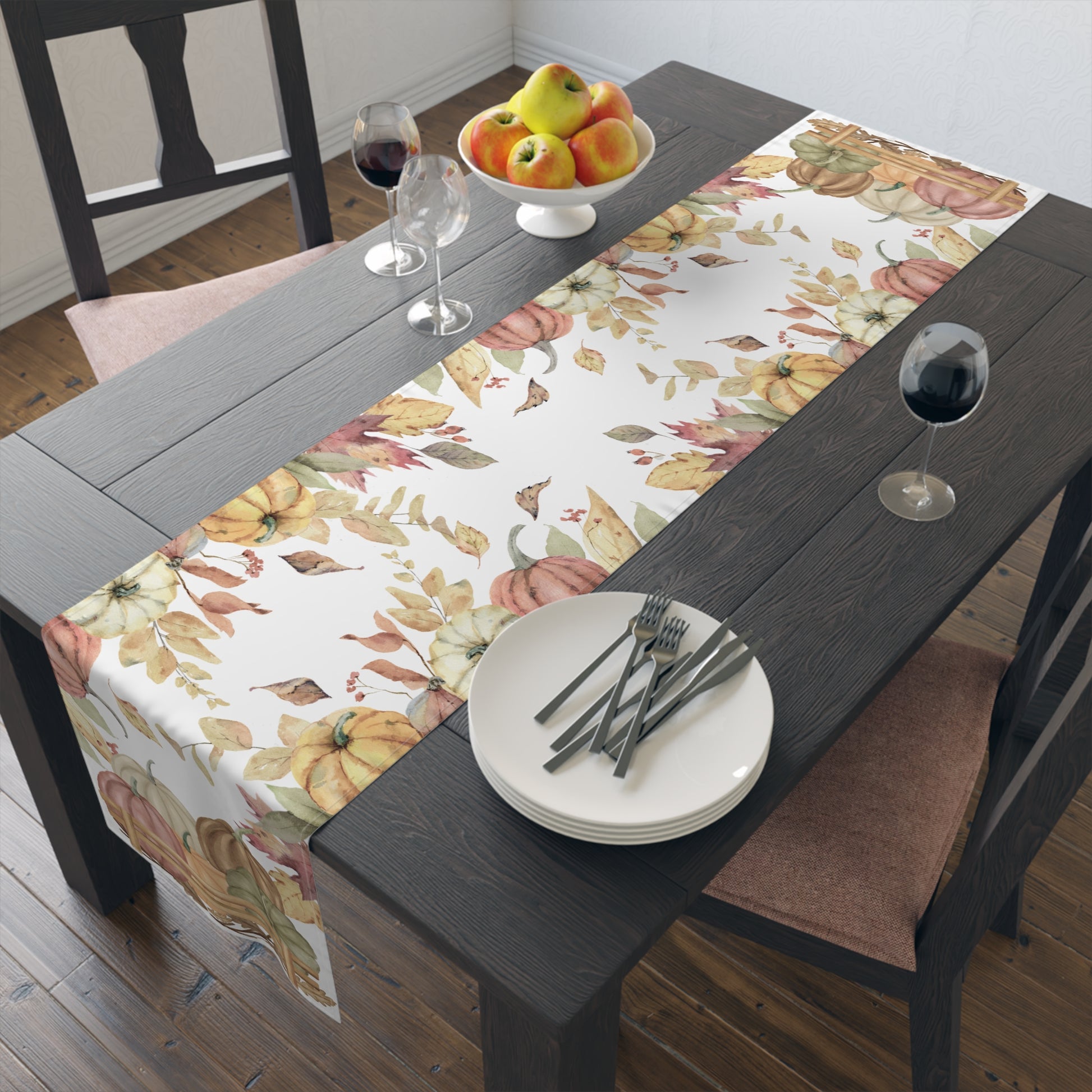 Dining table with Pumpkins table runner with autumn leaf and pumpkins pattern printed on front of this Pumpkins table runner, plates, and wine glasses.