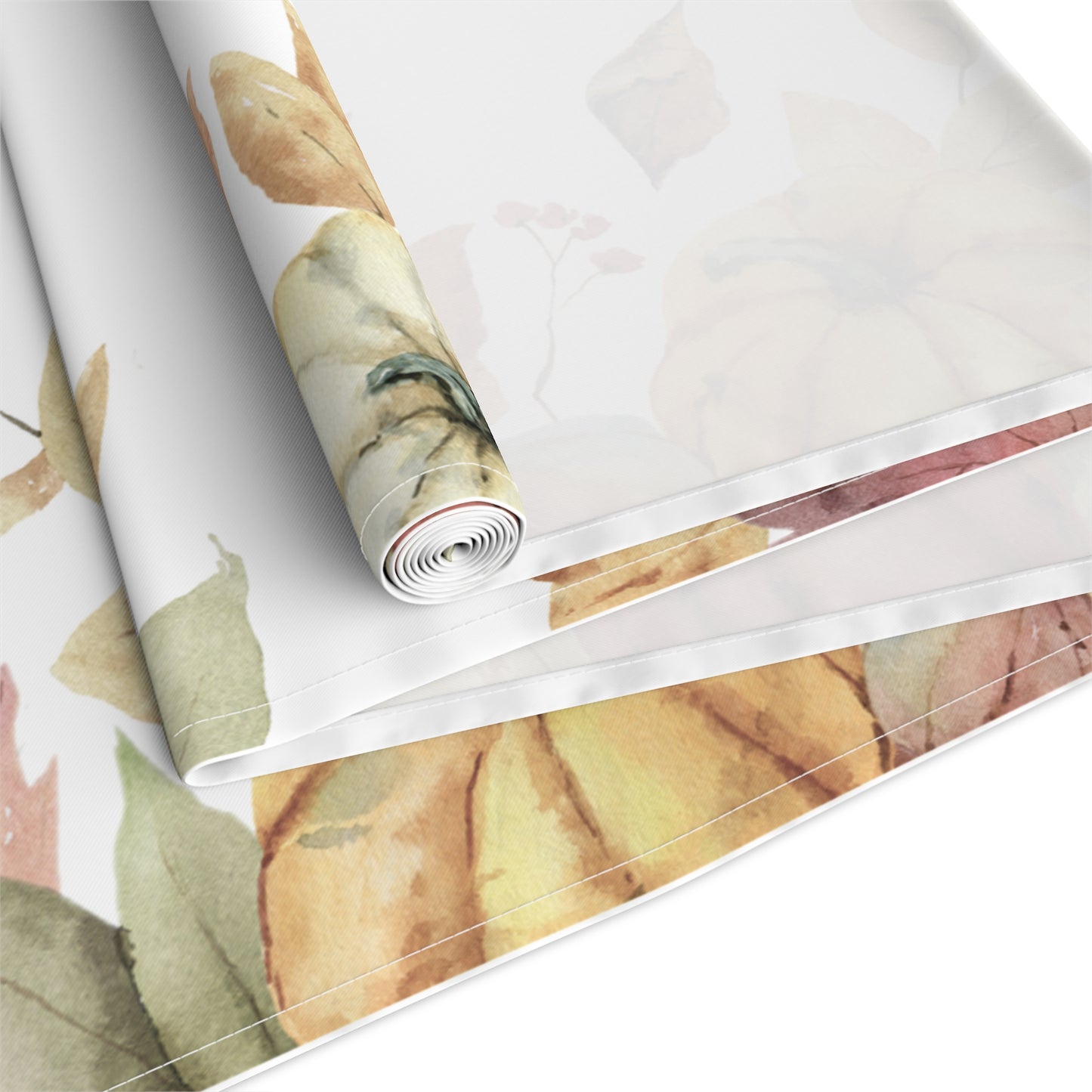Table runner with autumn leaf and pumpkins pattern printed on front of this Pumpkins table runner, rolled and folded on a white background