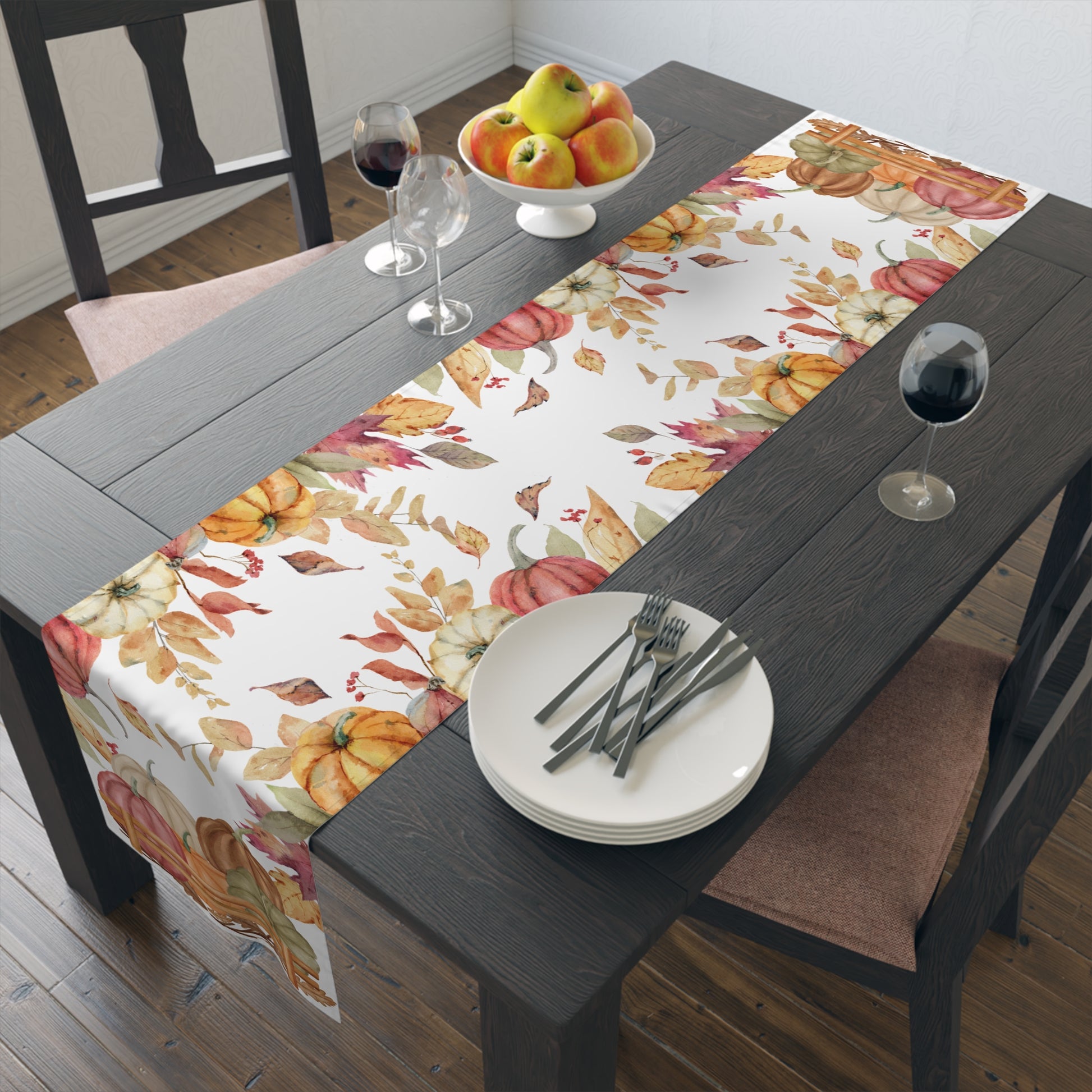 Dining table set with a colorful fall-themed table runner with autumn leaf and pumpkins pattern printed on front of this Pumpkins table runner, plates, and glasses.